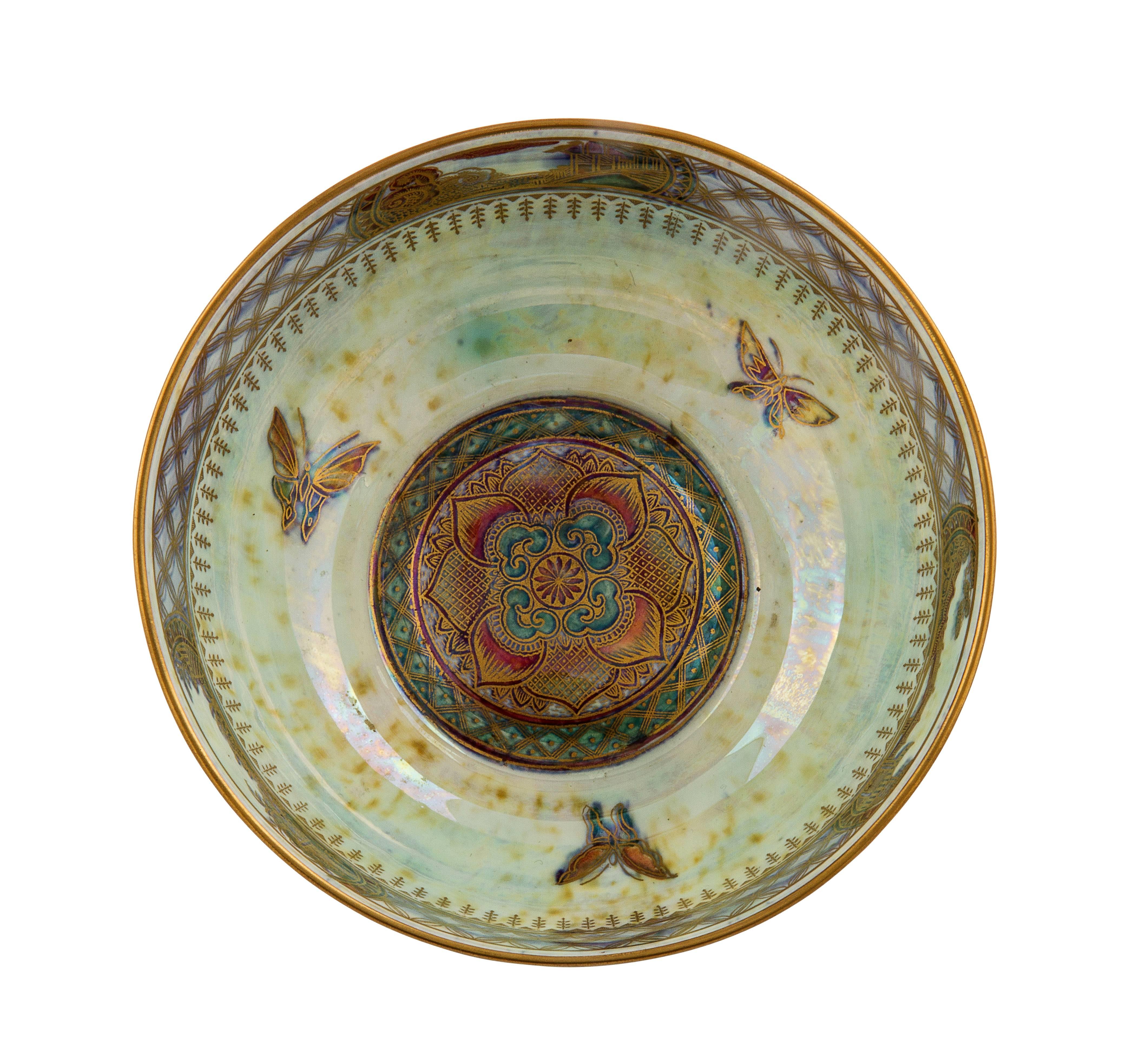 Art Deco wedgwood porcelain fairyland lustre butterfly bowl, designed by Daisy Makeig-Jones, the interior with mottled opalescent green-blue ground, with finely-painted gilt butterflies to well, the exterior painted with a mottled rubyred-gold