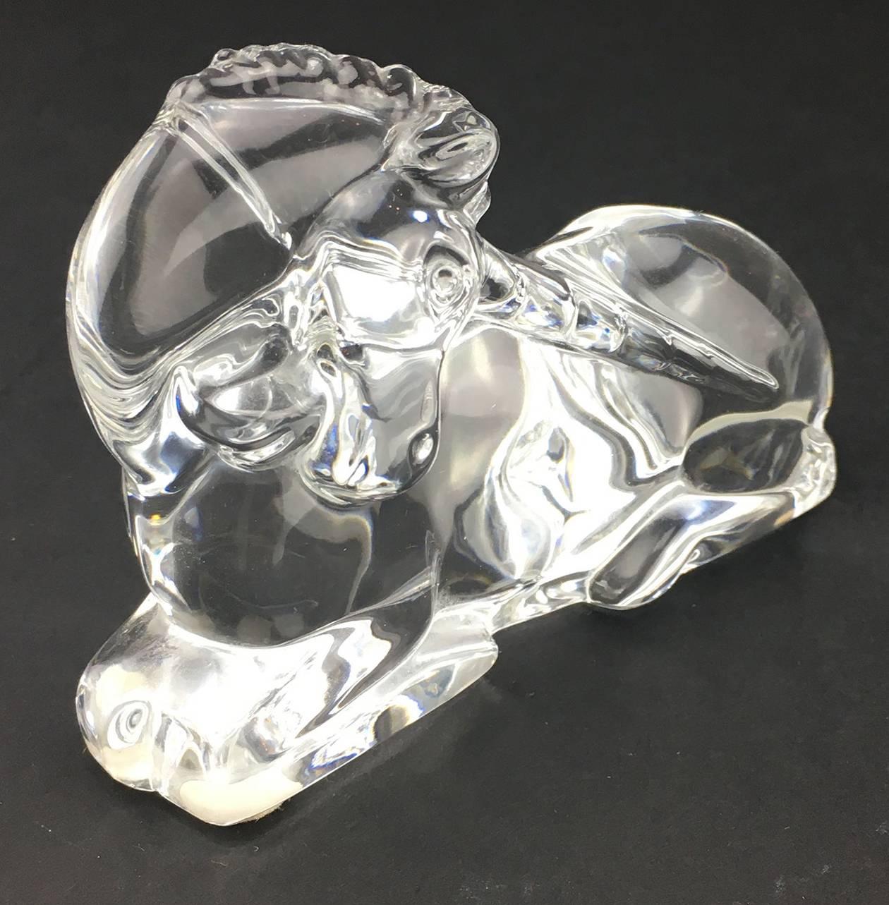 Baccarat Crystal Sculptural Figure of a Unicorn, the colorless, clear glass molded into the shape of a unicorn lying down on all fours, with its head down
and to the side.
Stamped to underside.
3 1/2