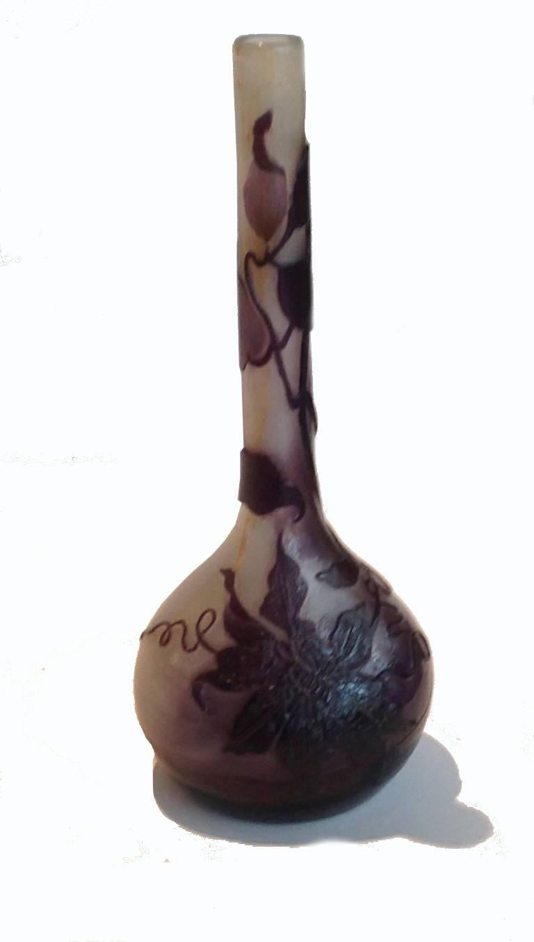 Galle's life spans a good two-thirds of the 19th century (1846-1904). He is most famous for creating vessels that combine cameo glass techniques in the depiction for naturalistic floral and foliate specimens. This is a long-necked vase, its