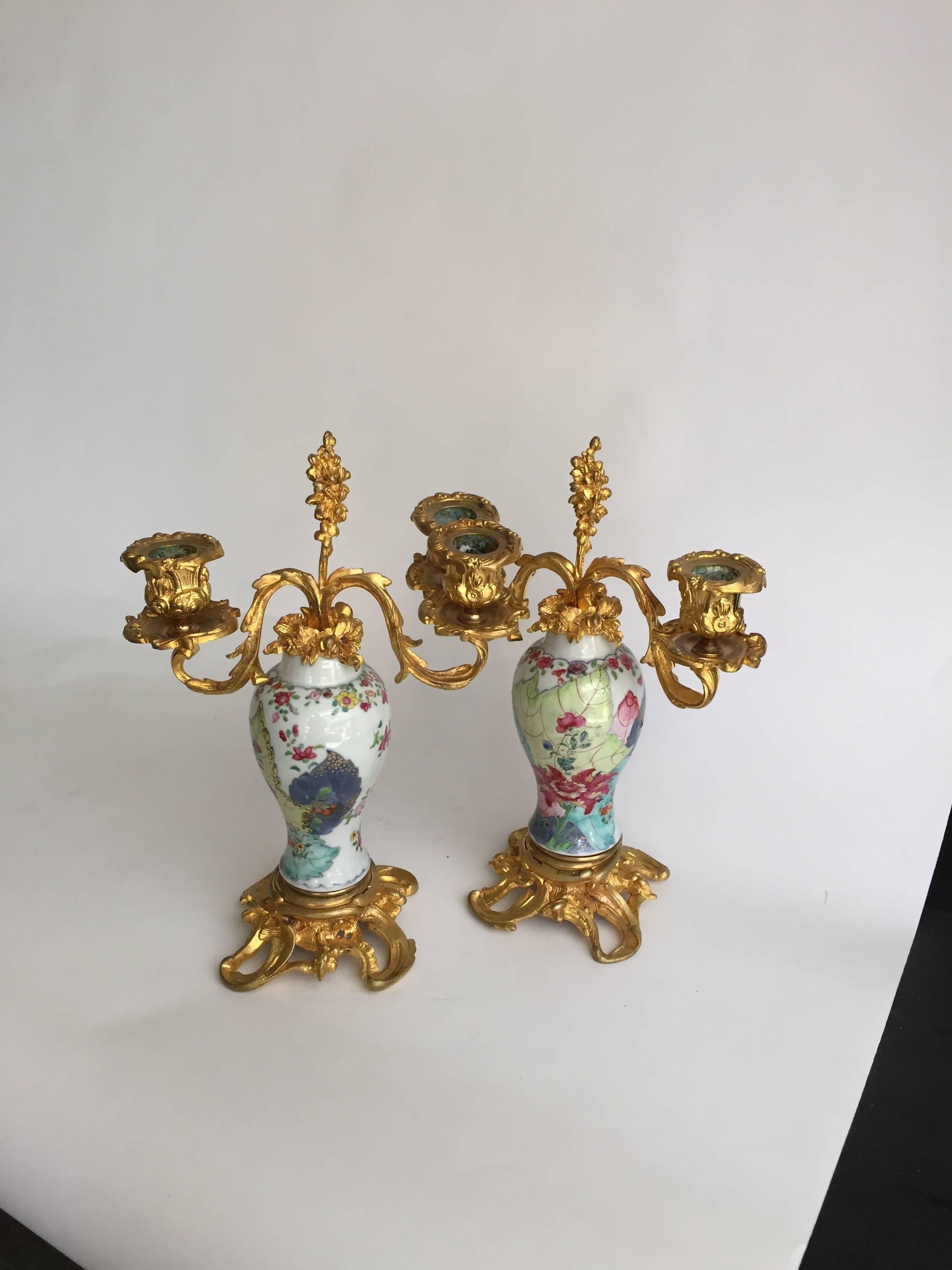 Chinese export porcelain pair of vases painted in the “Tobacco Leaf” pattern, mounted as two-light candelabra in Fine Rococo ormolu (gilt bronze metal) mounts. The vases from a mantel garniture, Qing dynasty, 18th century. Unmarked. 11” H.