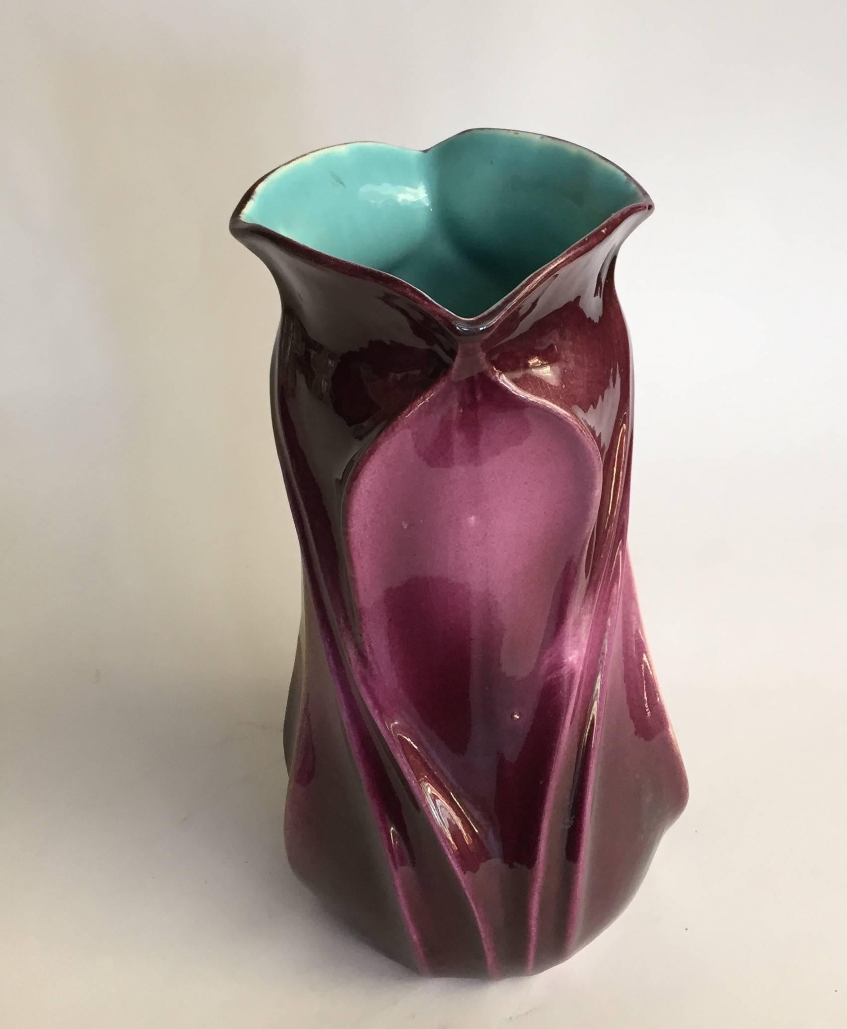 French Sarreguemines faience vase, of Art Nouveau floriform molded form, the undulating and swirling form creating an abstracted flower, enameled with ombre shades of amber to purple- to turquoise. Impressed marks, circa 1915. Measures: 10” H. Minor