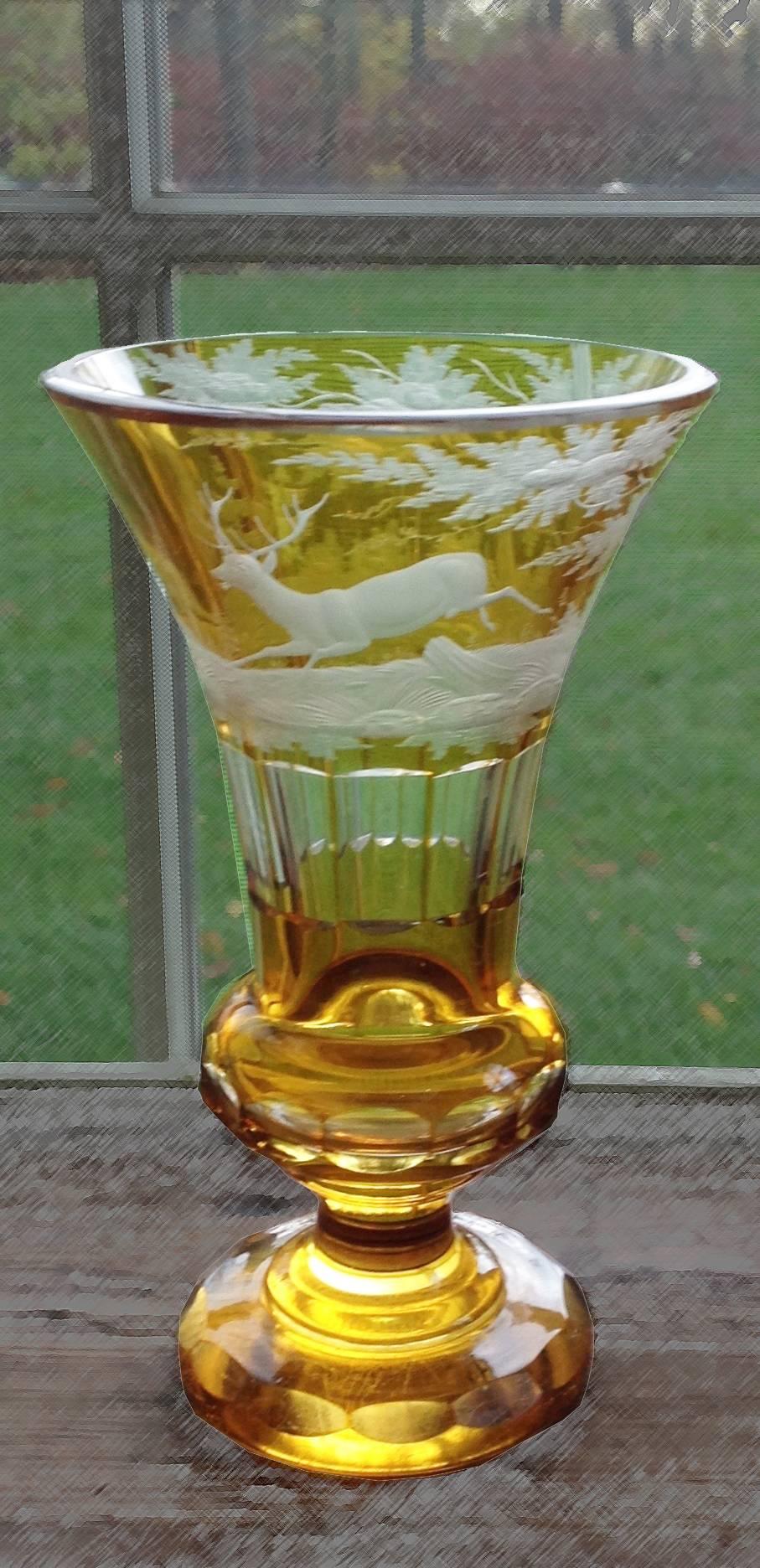 German-Czech Bohemian amber glass conical vase, acid-etched with hunting scene of deer in deep forest over cut-panelled sides and facet-cut hollow knop, circa 1840-1880. Measures: 8¾” H.