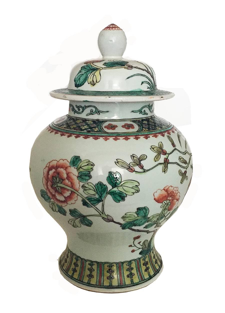 French Samson-style Chinese export-style porcelain Famille Verte Wucai Q'ing dynasty pair of Baluster-form jars and domed covers with pointed Ovular knops, painted with Ho-Ho Birds in bright enamel hues on branches in flowering trees, between bands