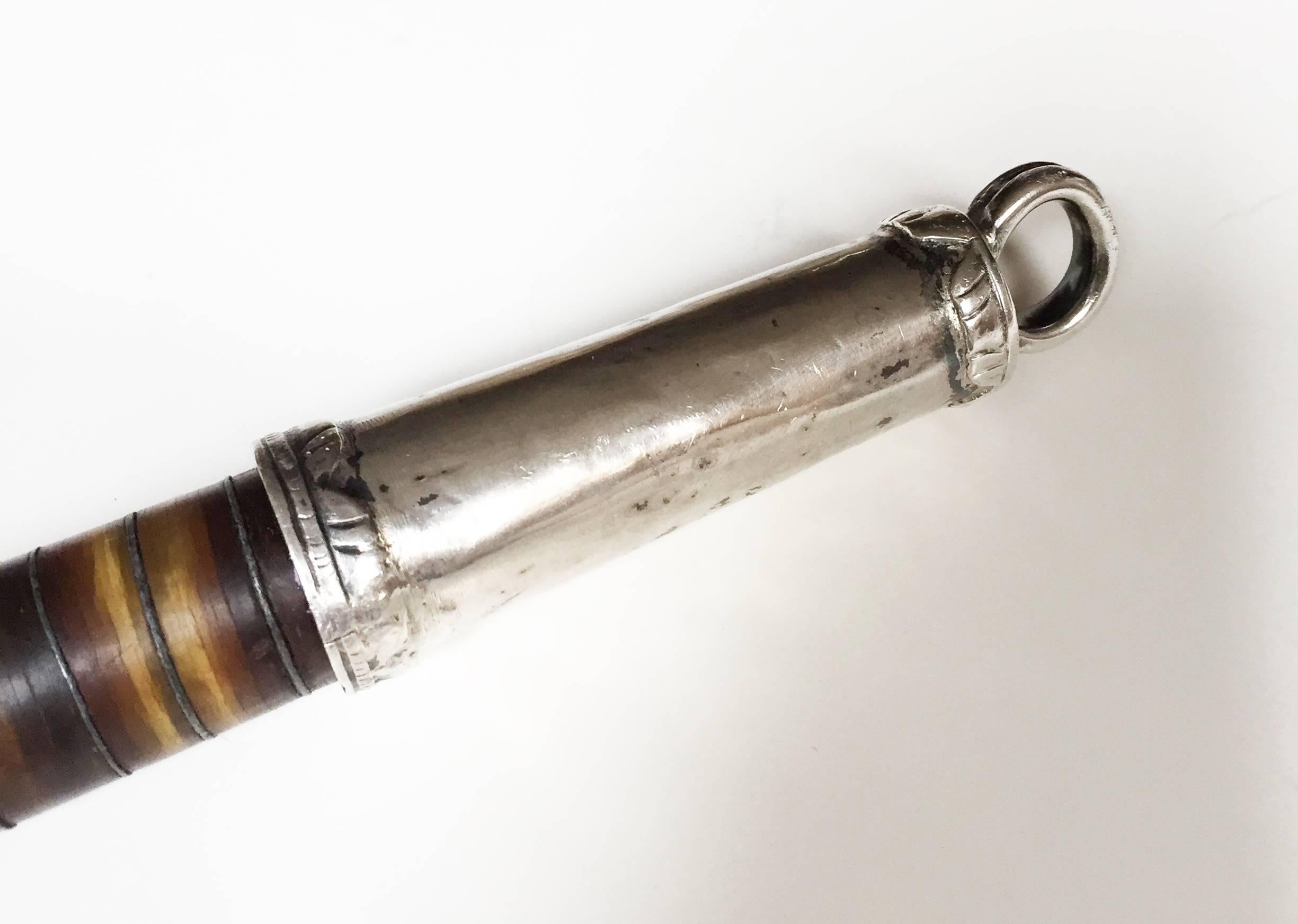 Rare Victorian Scottish banded or cairngorm agate, sterling silver ceremonial baton or swagger stick, circa 1890-1910.

The impressive lightly-flaring stick-form steel baton mounted with sliced lateral 