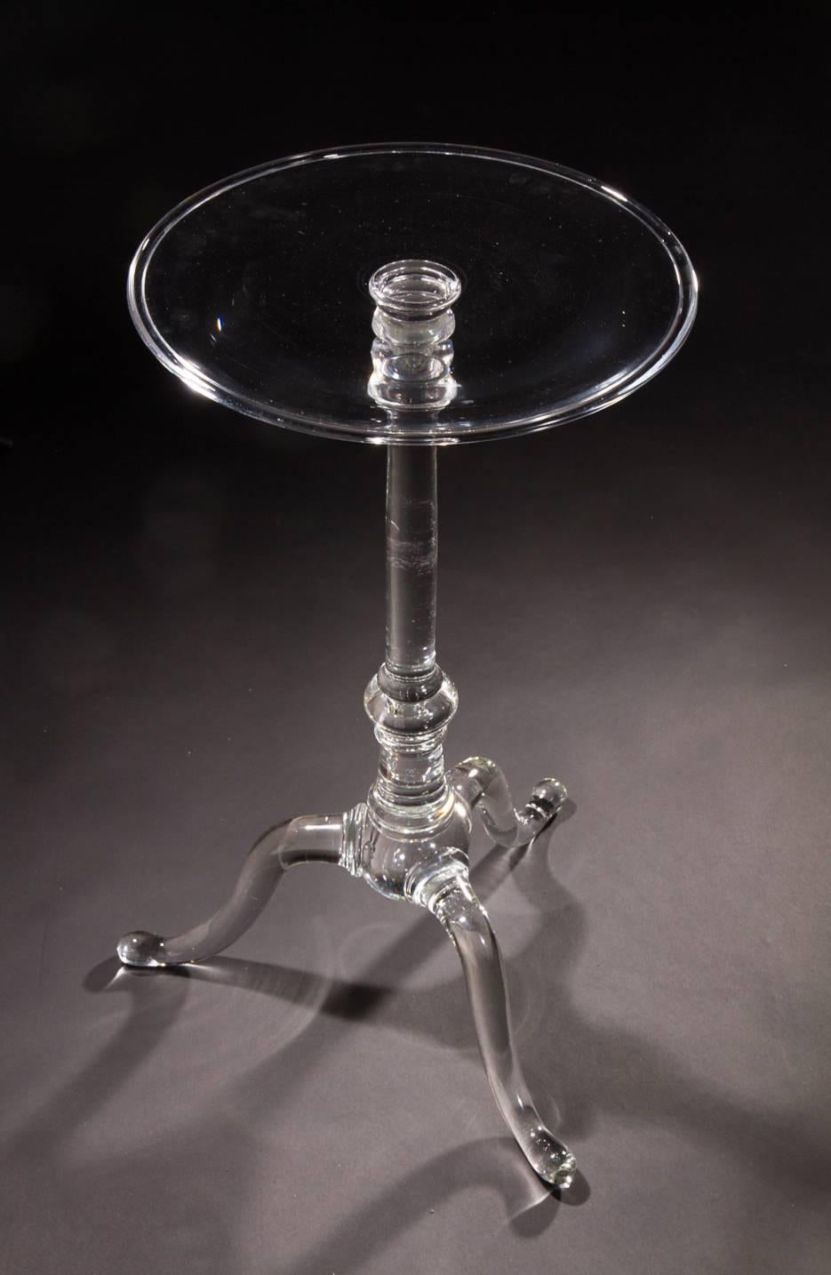 The central pillar issuing tripodal legs and pad feet, the table top of simple cylindrical form. The clarity of the glass is remarkable, as is the size of the table, which is completely handblown. Art Reed's table is a tour-de-force of the