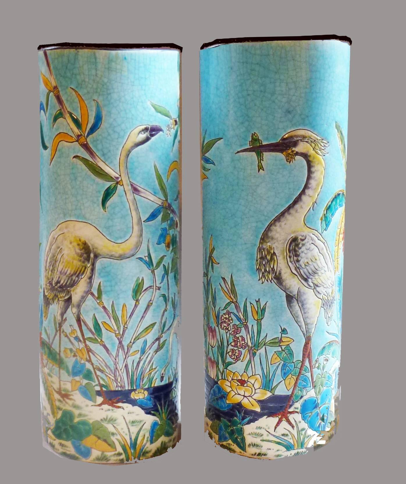 French Japonisme Longwy pair of faience vases, circa 1885.

Painted with turquoise grounds and with polychrome enamels, in cloisonne-enamel style with storks to the fronts, the backs with bamboo, palm and banana trees. 

Signed to the underside