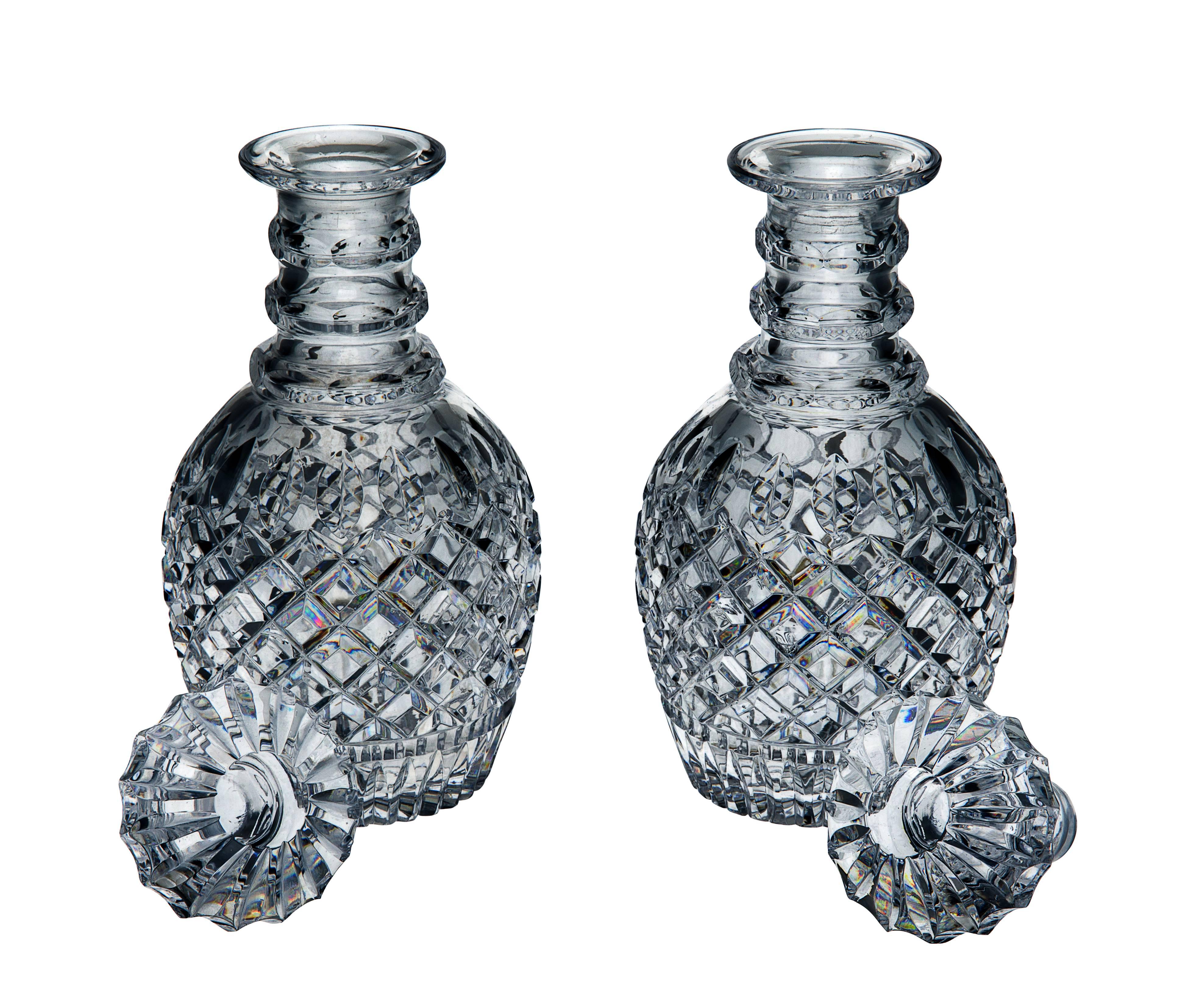 Pair of Victorian glass blown-molded English barrel-shaped spirit decanters and stoppers with three applied cut-facetted rings to neck under everted lip, the bodies cut with punties above a wide band of diamonds above vertical flutes and star cut