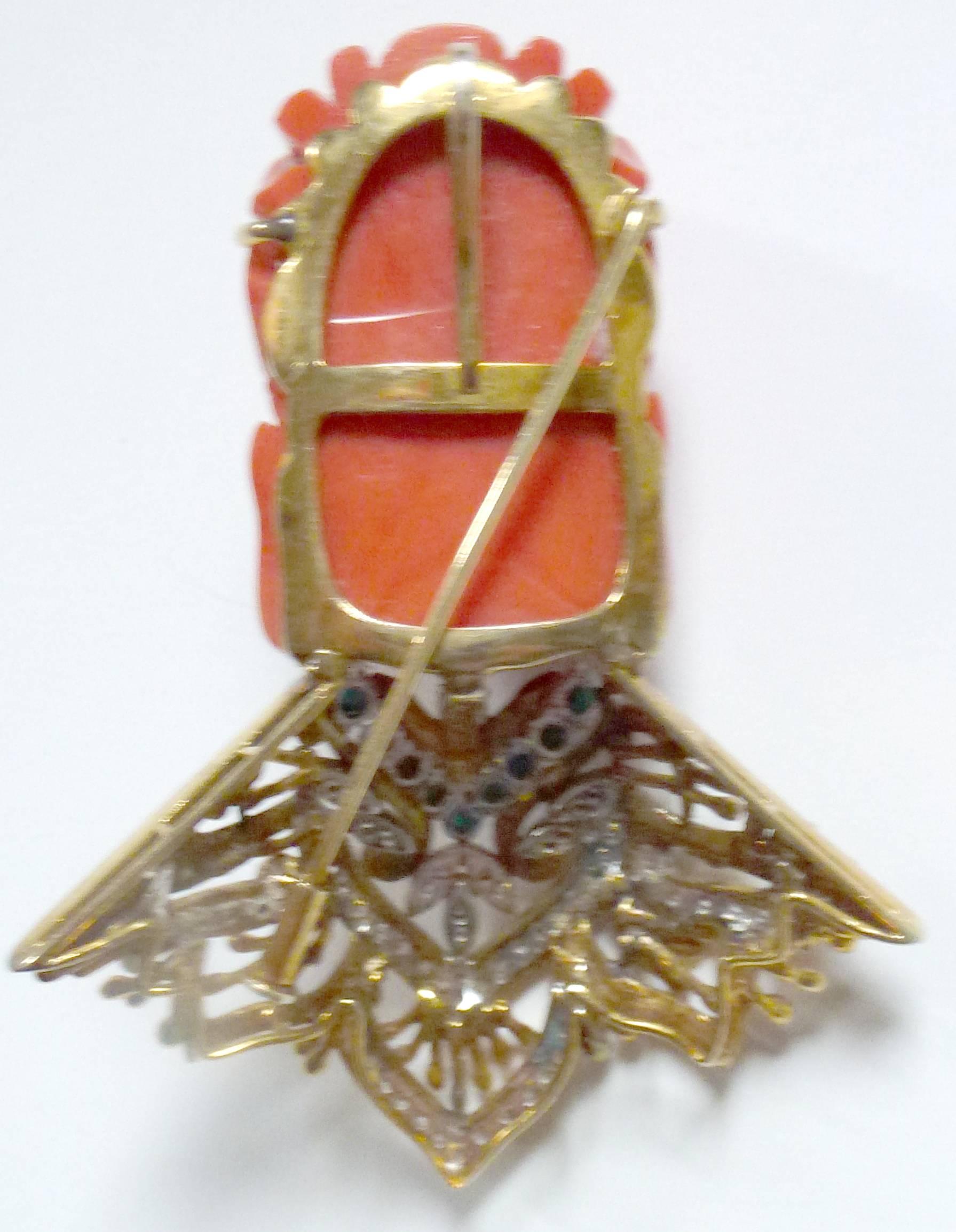 Kenneth H. Carved coral, diamond and 18-karat gold convertible brooch , the 18-karat frame set with the large carved figural head of a Buddha or Guanyin carved in red coral, the forehead inset with six diamonds forming hairband, one diamond between