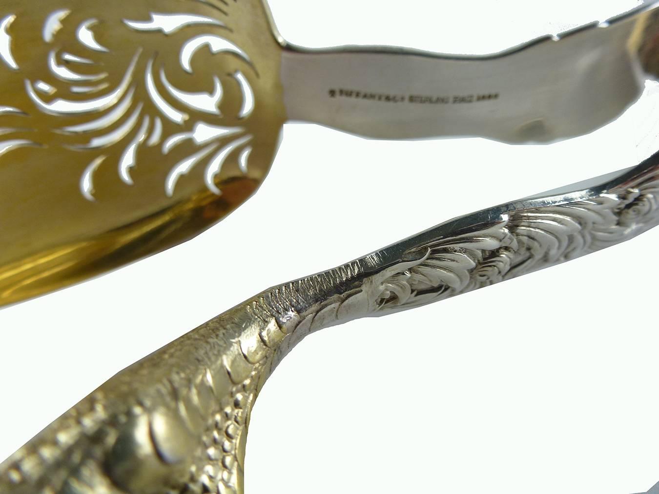 American Tiffany & Co. sterling silver pair of ice tongs chrysanthemum pattern.

Tiffany sterling silver gold-washed pair of ice tongs, with the distinctive 