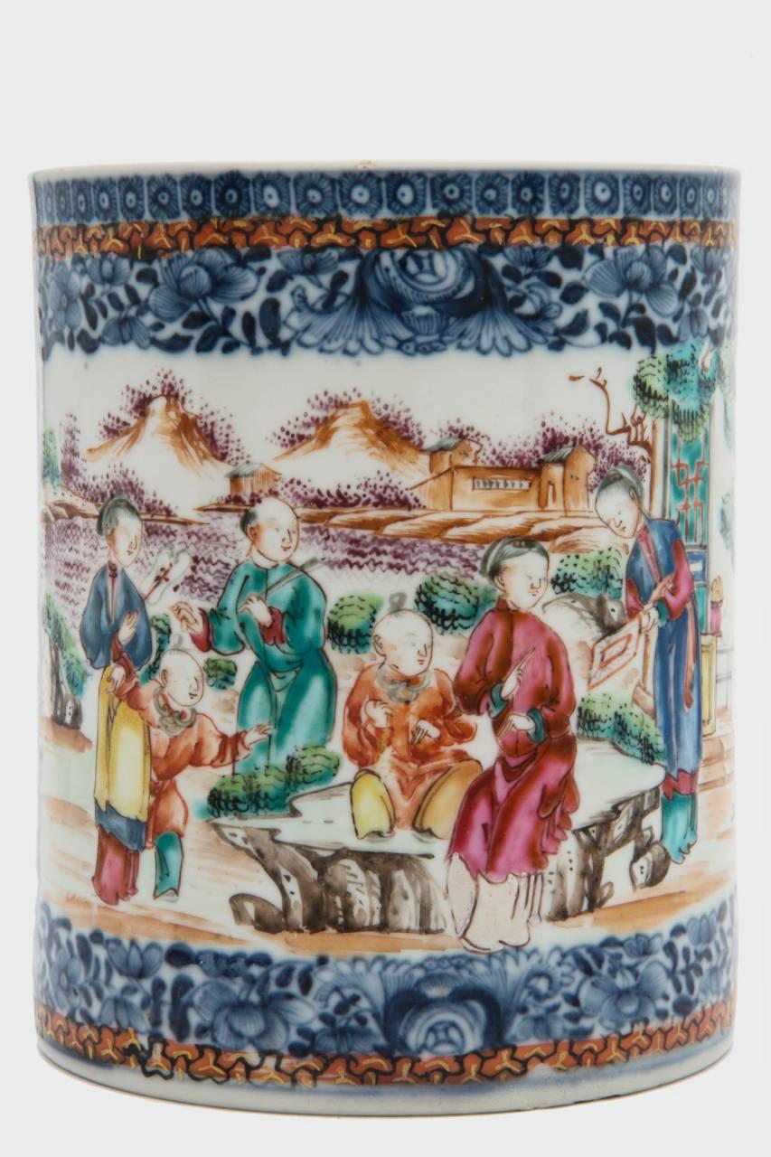 Chinese export porcelain suite of three Qianlong period mugs in three sizes enameled in underglaze blue and painted with Y-ground in iron red and gold and blue underglaze, centering scenes in shaped reserves.

Unmarked.

Measures: 5.5