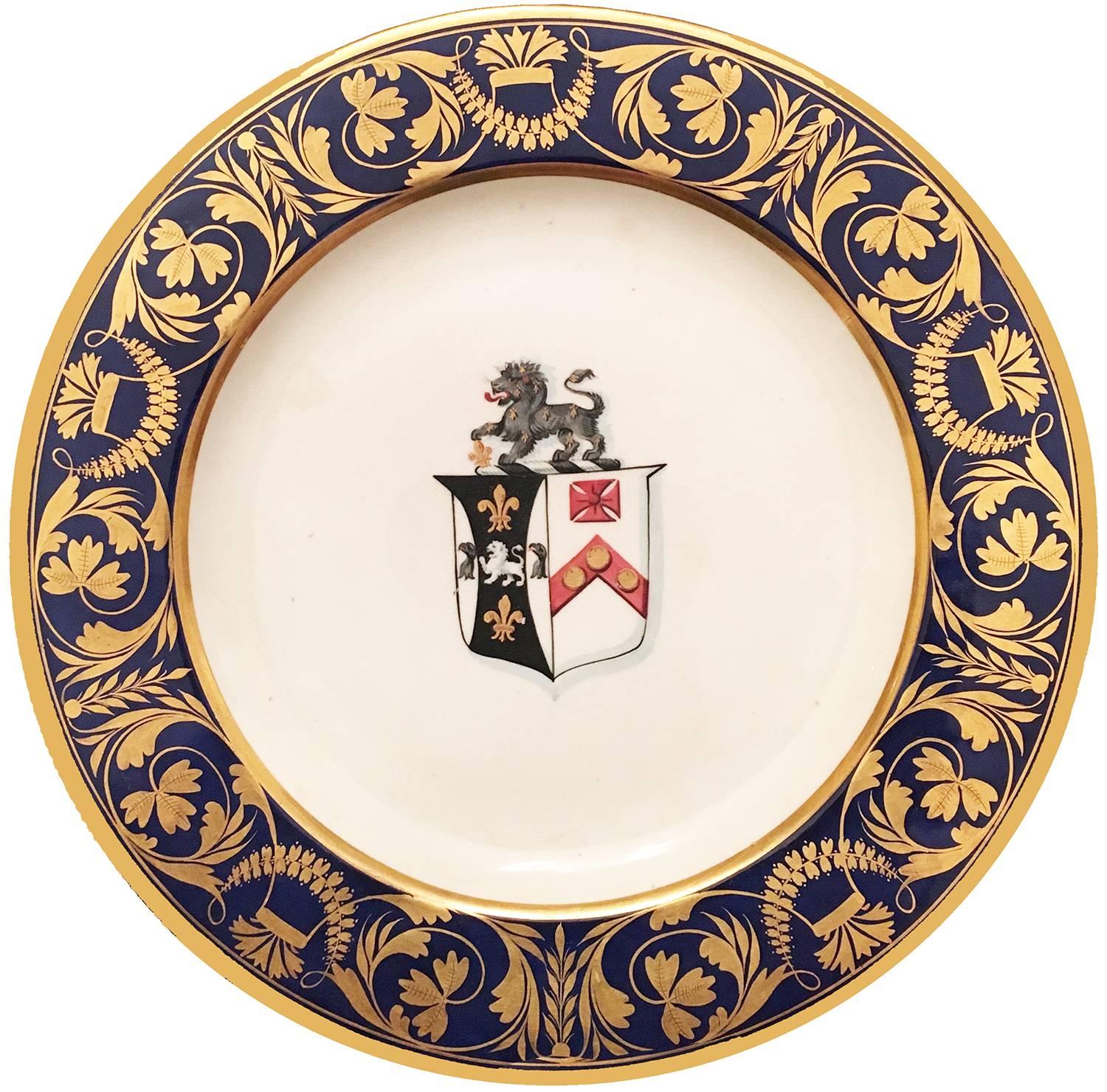 English Bloor derby porcelain pair of blue-ground armorial dinner plates, with extensive gilt cartouches and foliate patterns between gilt bands, centring an armorial crest.

Marked in iron-red enamel to the underside with crown, script D, crossed