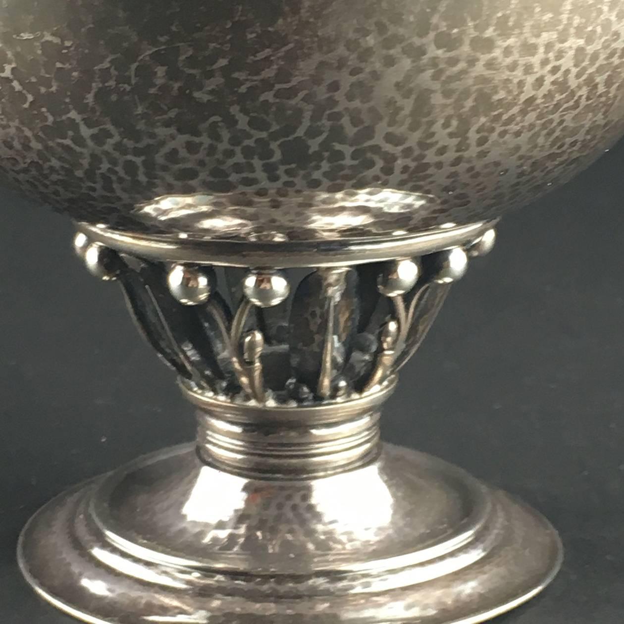 Danish Georg Jensen Silver covered bowl on stepped circular base, the openwork berry stem supporting a circular bowl with everted rim, the cover with berry finial. The form often referred to as 