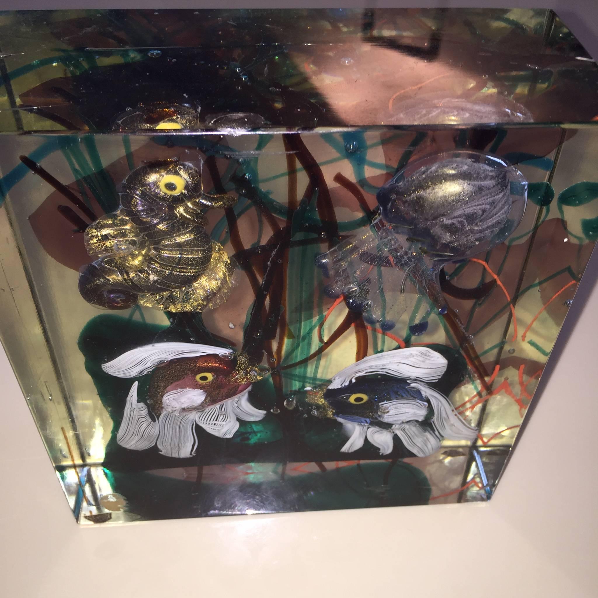 First production early 1950s. Colorless glass with polychrome smelted underwater decor, a sea horses, a jellyfish and two fishes. Surfaces on all sides, ground smooth to a cube. 

Lit: Barovier, Marina; Mentasti Barovier, Pink; Dorigato, Attila, Il