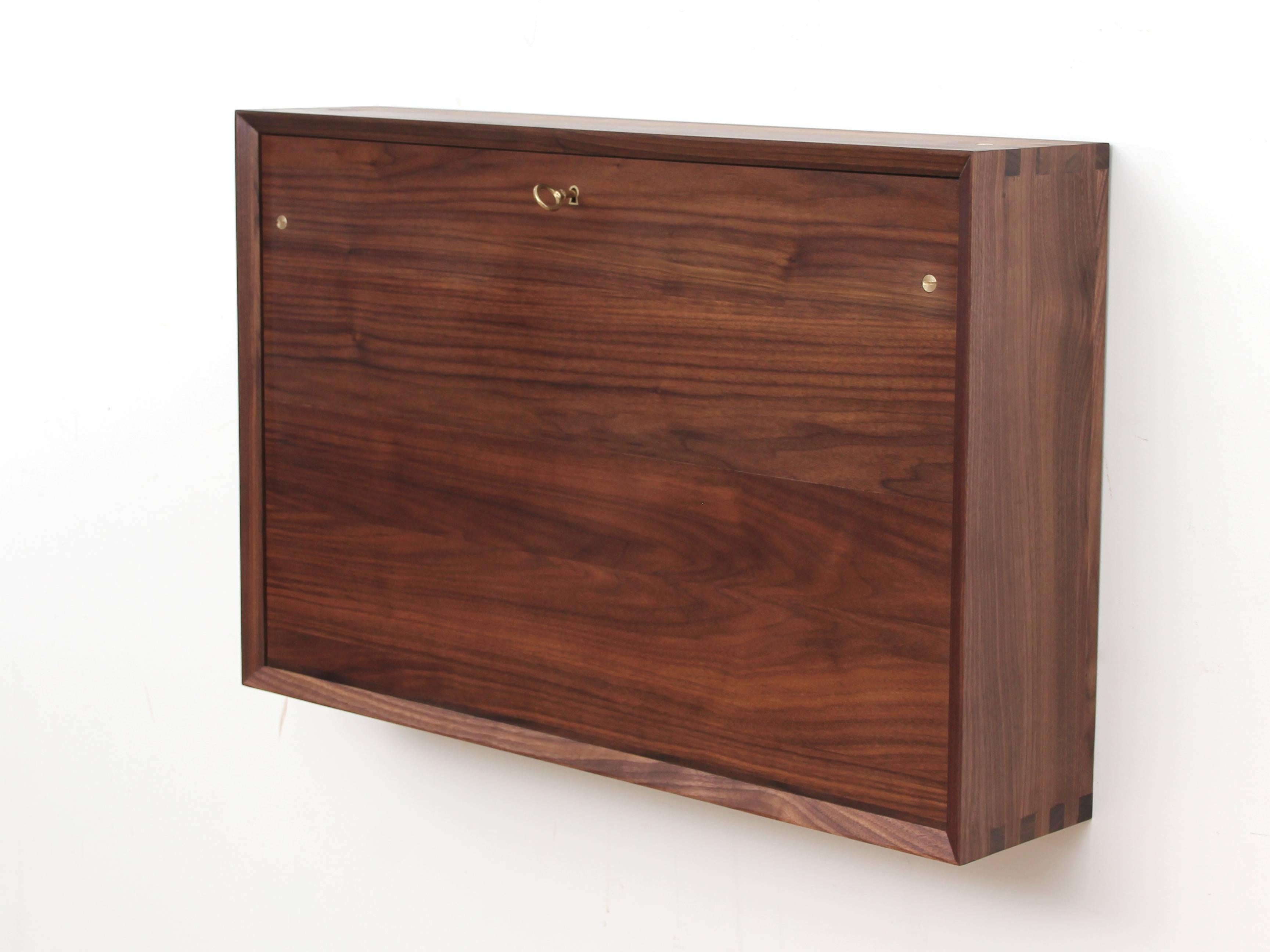 Wall secretary desk, model Odense. Oiled solid walnut. Natural leather interior full grain untreated. Designed by Møbler Gallery. Made in France by master craftsmen. Wood from eco-sustainably managed forests.
Traditional cabinetmaker work. To hangs