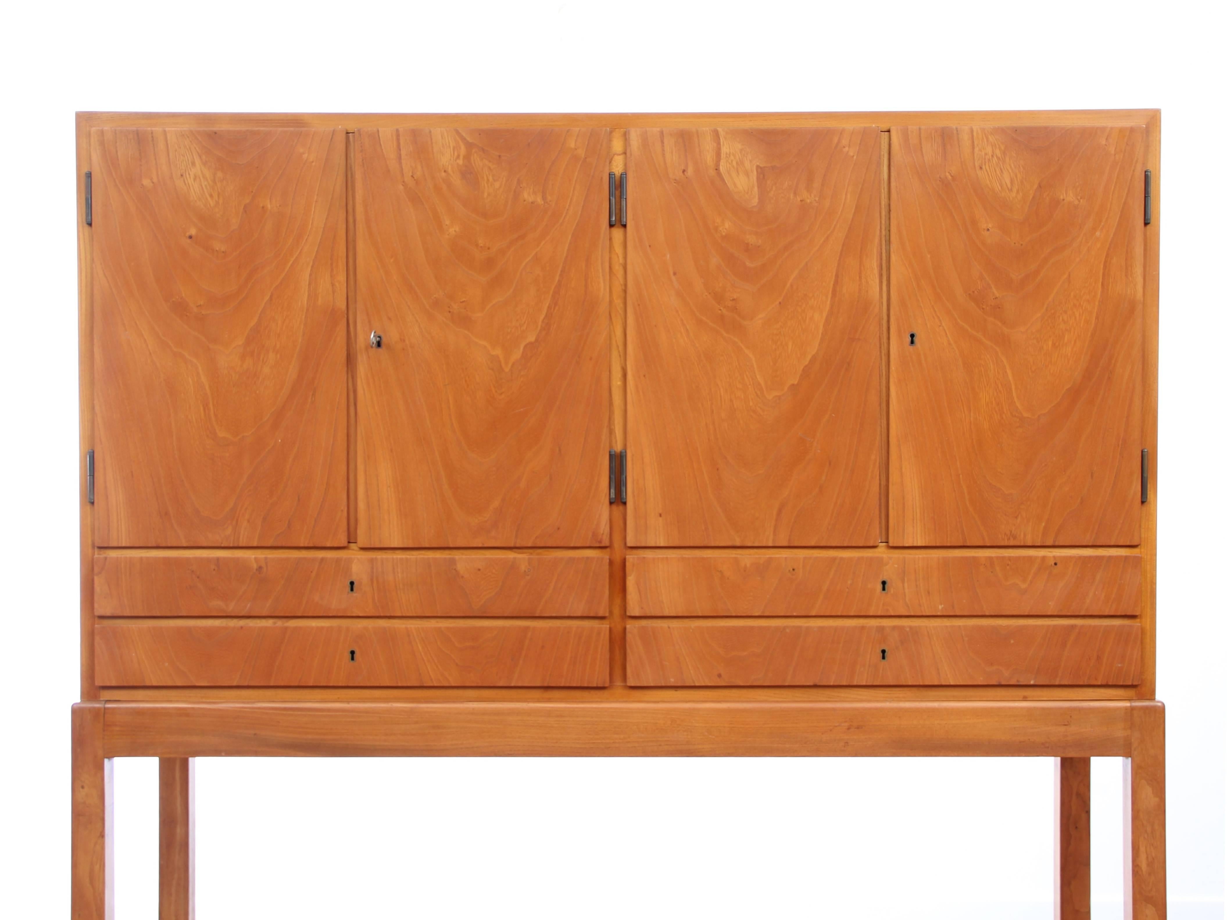 Scandinavian firm elm with two compartments and four drawers. Modular shelves. Interior maple. Swedish work.
