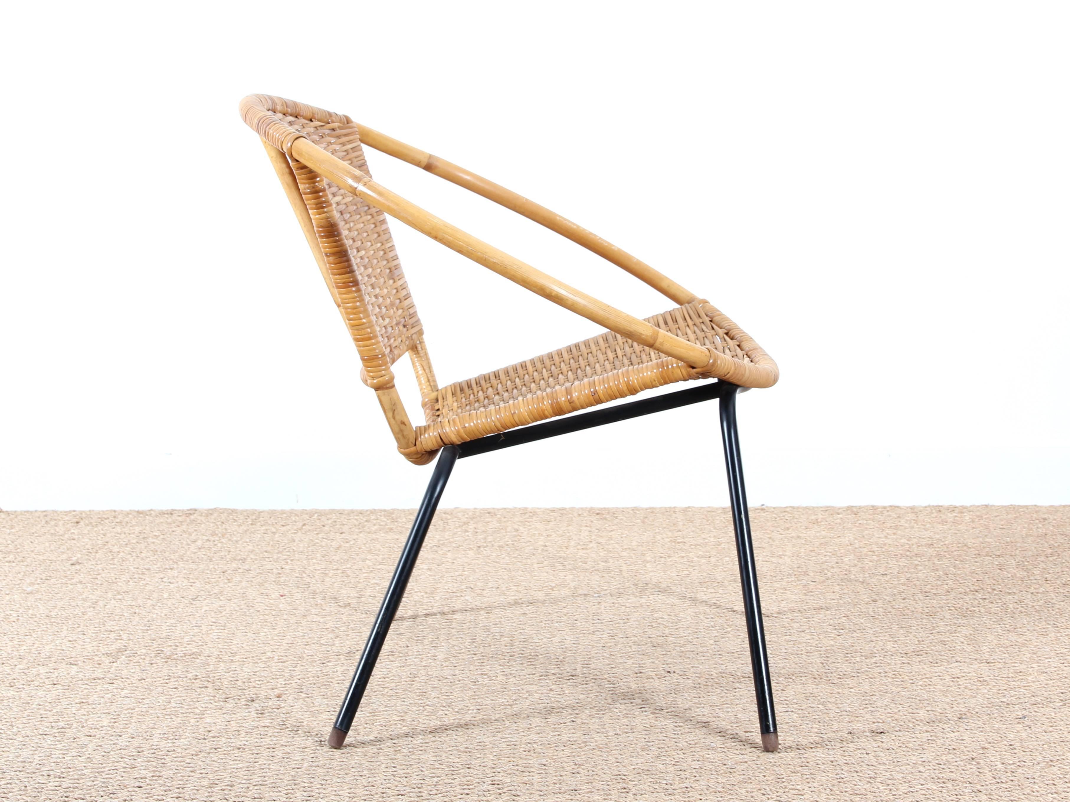 Scandinavian rattan chair. Base in black lacquered steel. Caps teak feet.

In perfect original condition.