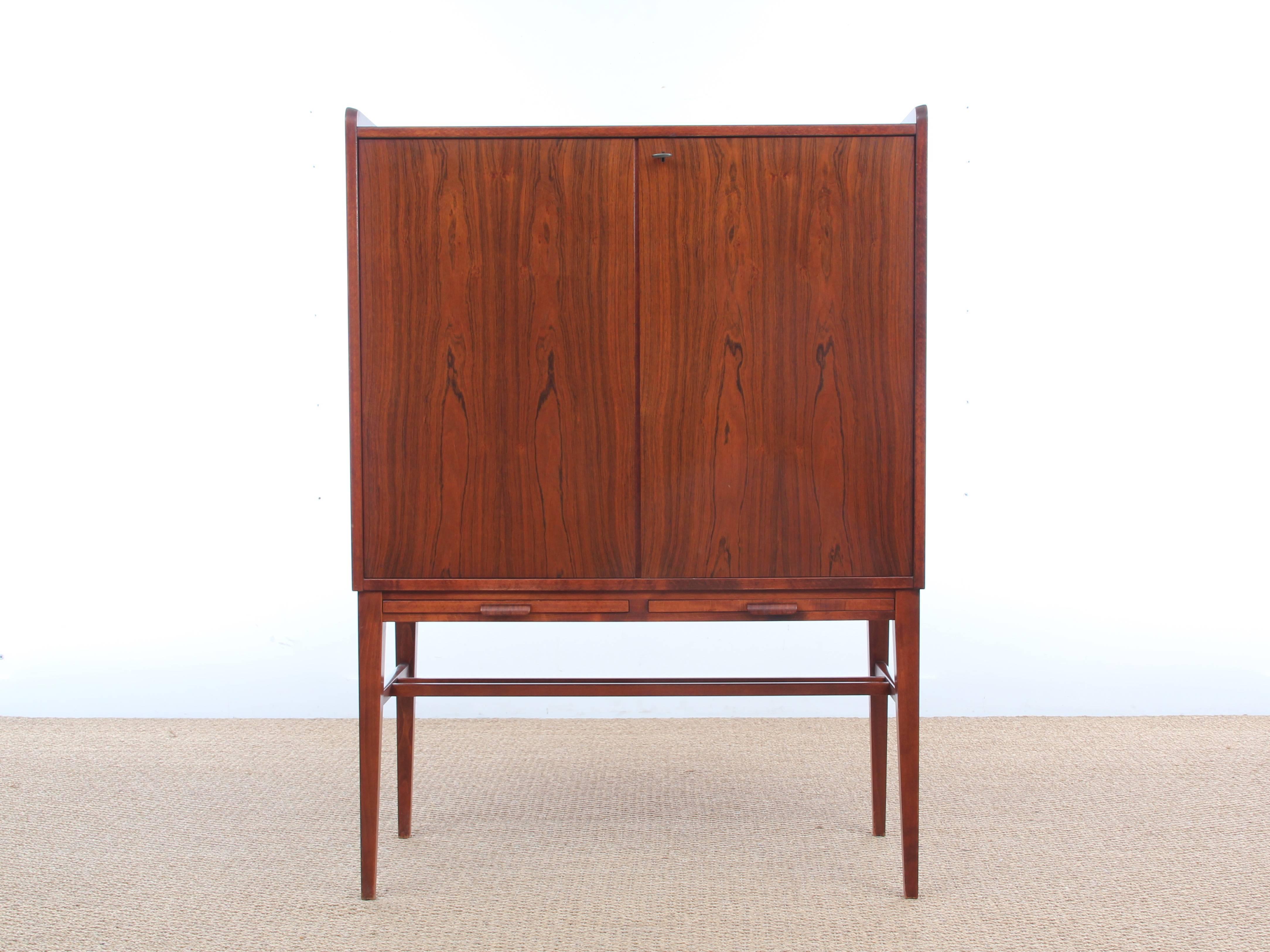 Mid-Century Modern Scandinavian cabinet in rosewood. Inside in maple. Three drawer. One loose shelve. Two sliding trays.