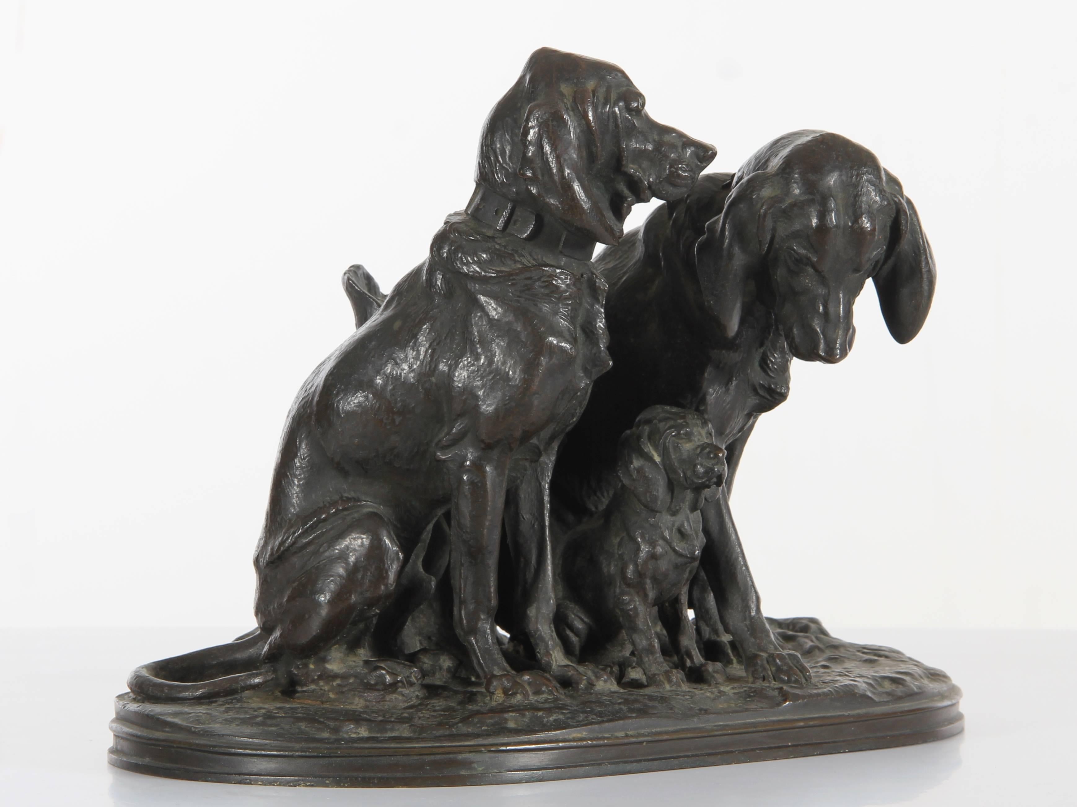 Alfred Jacquemart (French, 1824-1896) bronze figural group of three hunting pointers dogs, including a puppy, seated by a tree stump, on a naturalistic base of grass, leaves and roots. Original brown patina. Signed A Jacquemart on base.