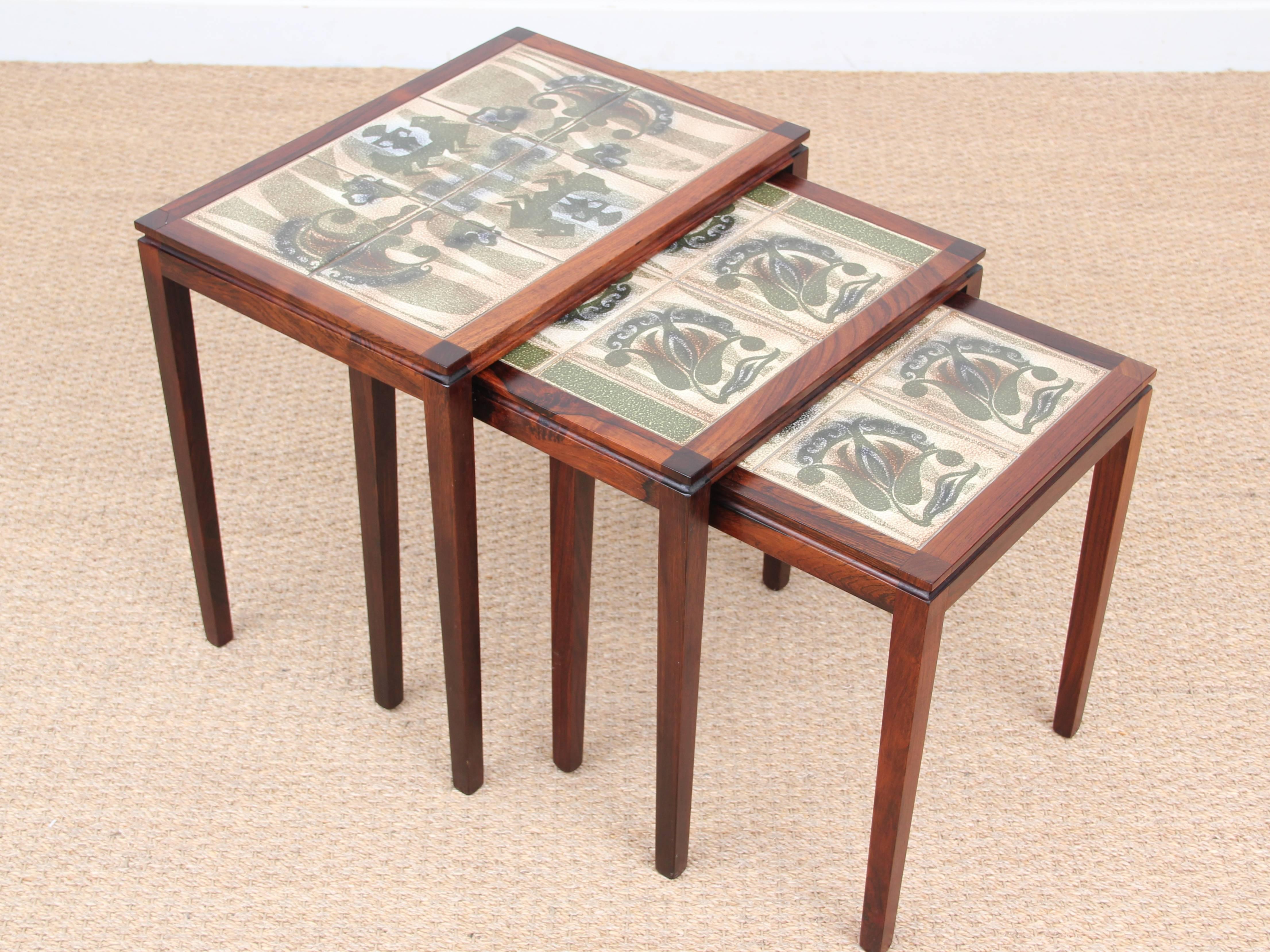 Mid-Century Modern Scandinavian nesting tables in Rio rosewood and ceramic tales.