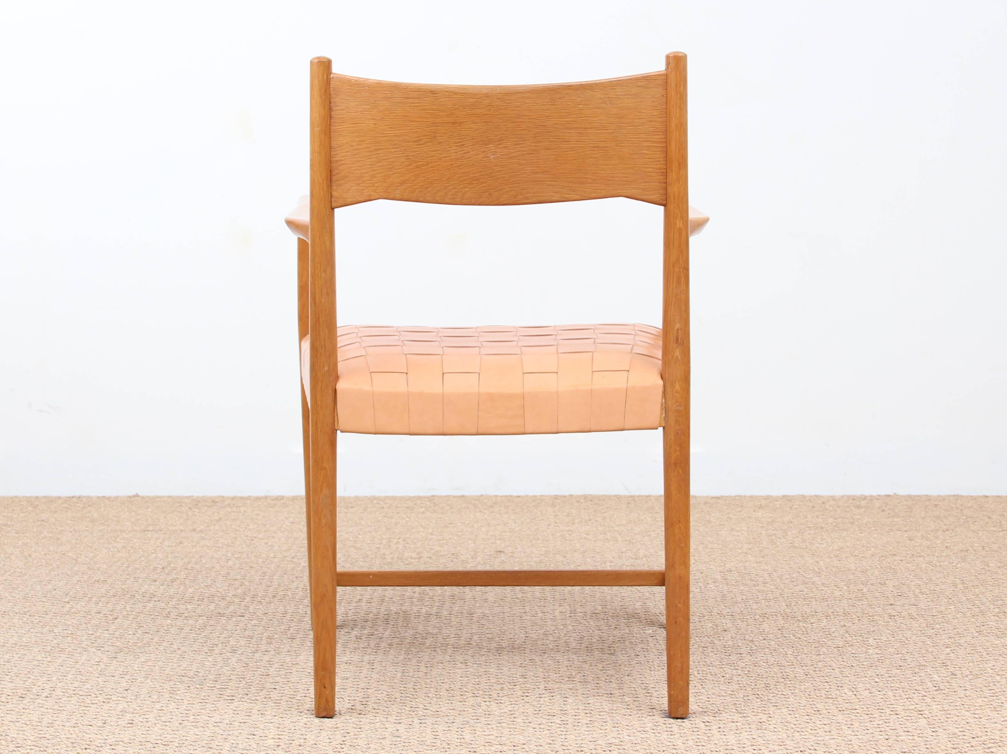 Mid-Century Modern scandinavian armchair model Århus Cityhall by Hans Wegner designed, circa 1940. Solid oak frame, seat reupholstered as original with natural leather straps.

The armchair was part of the furniture of the Århus Cityhall in