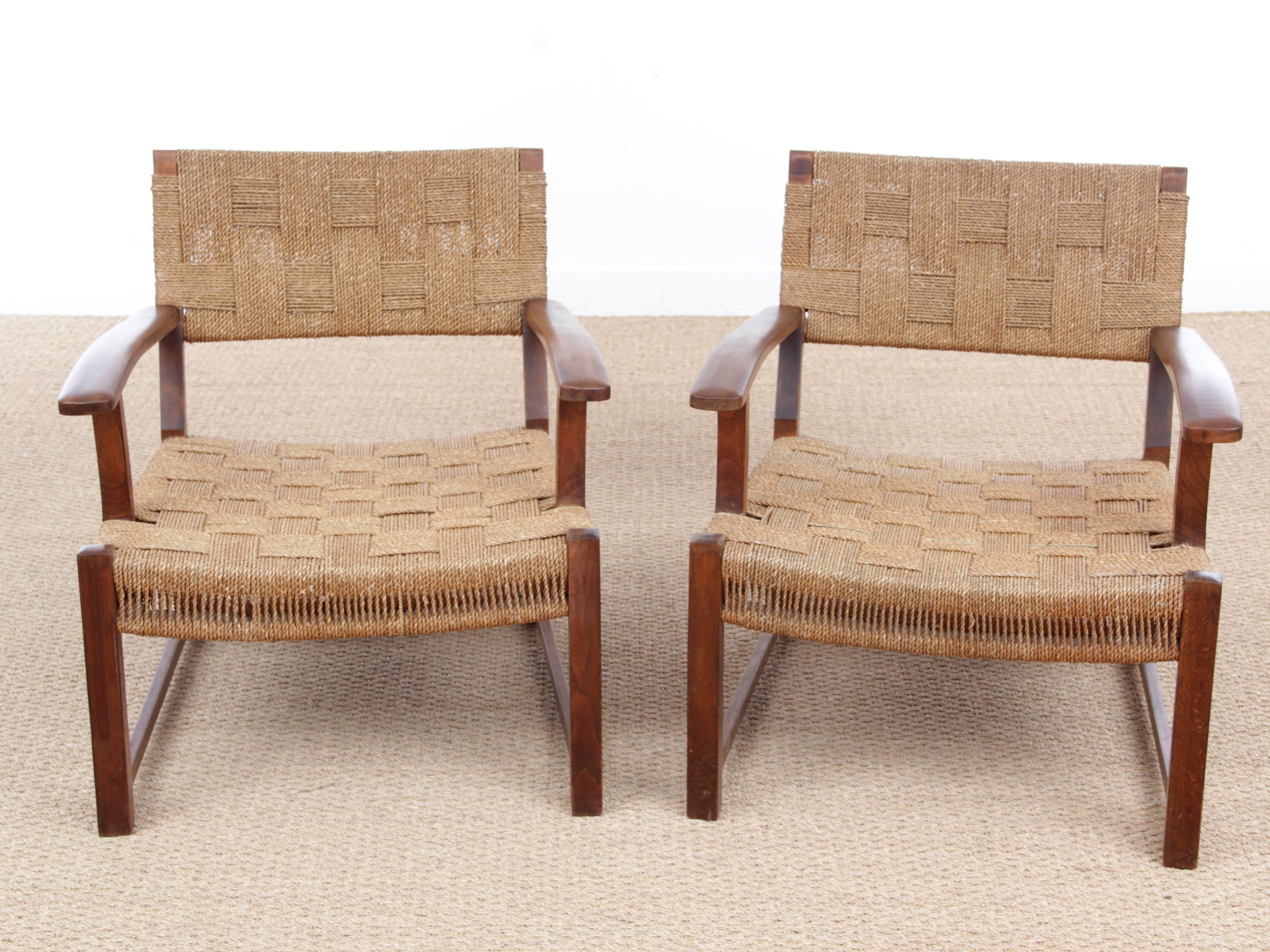 Mid-Century Modern pair of armchairs. Stained beech. Seat and back upholstered with woven sea grass Danish work from the 1950s.