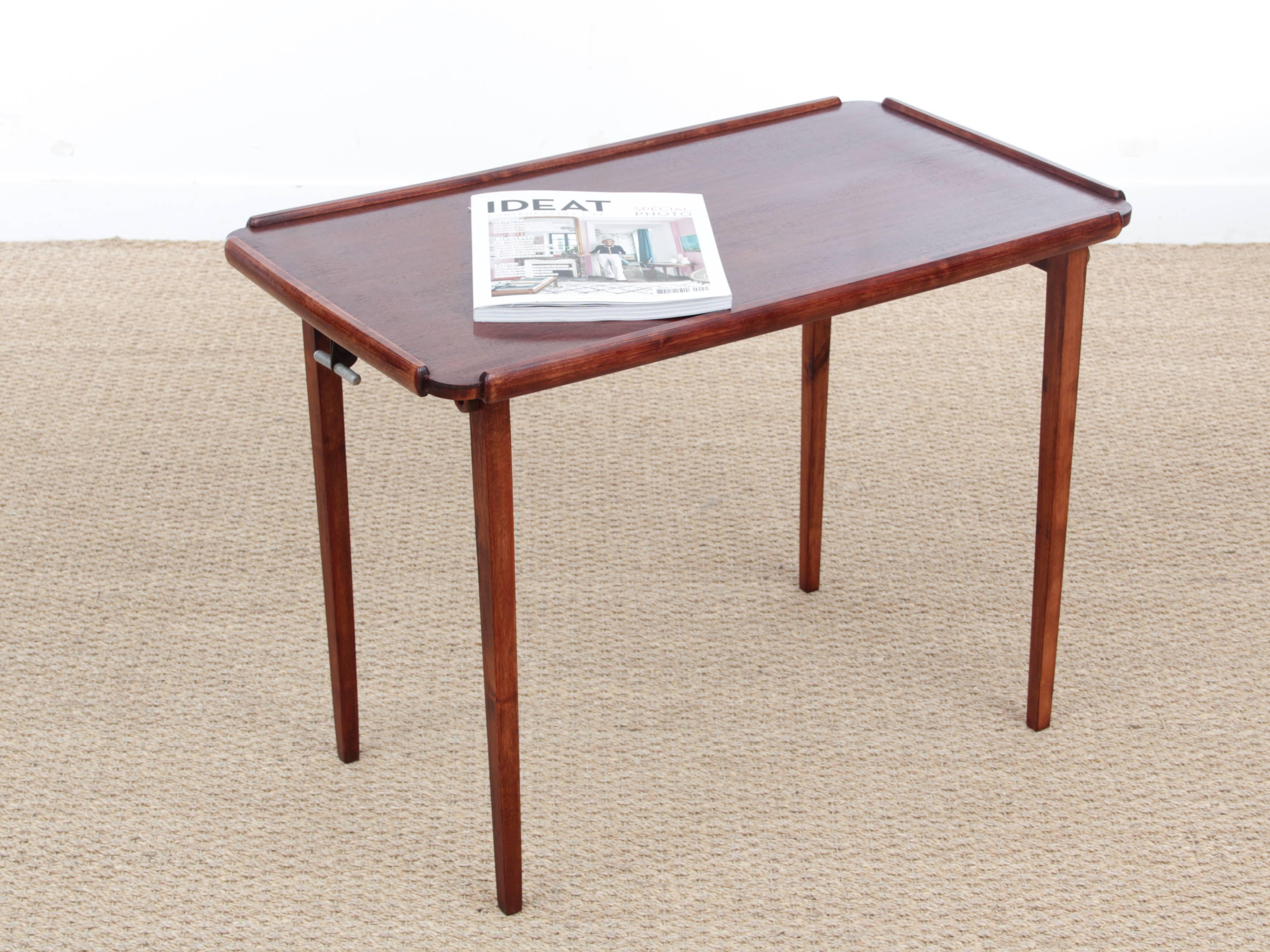 Mid-Century modern scandinavianfolding table in mahogany. An ingenious spring leaf system allows automatic opening and folding.
Swedish work from the 50s.