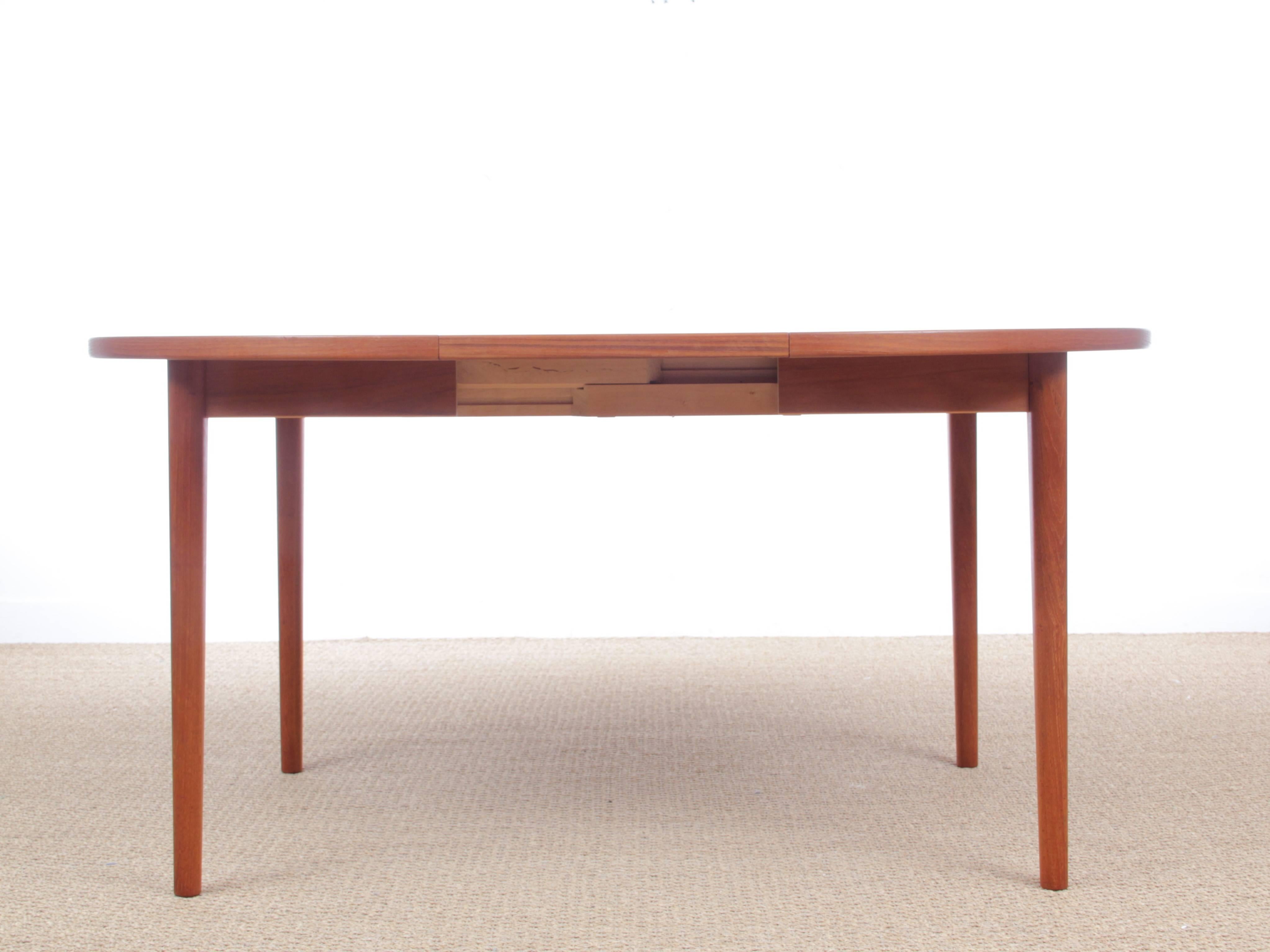 Mid-Century Modern Scandinavian round dining table in teak four-eight seats. One extra folding leave. Model Malta by Niels Jonsson for Troeds.