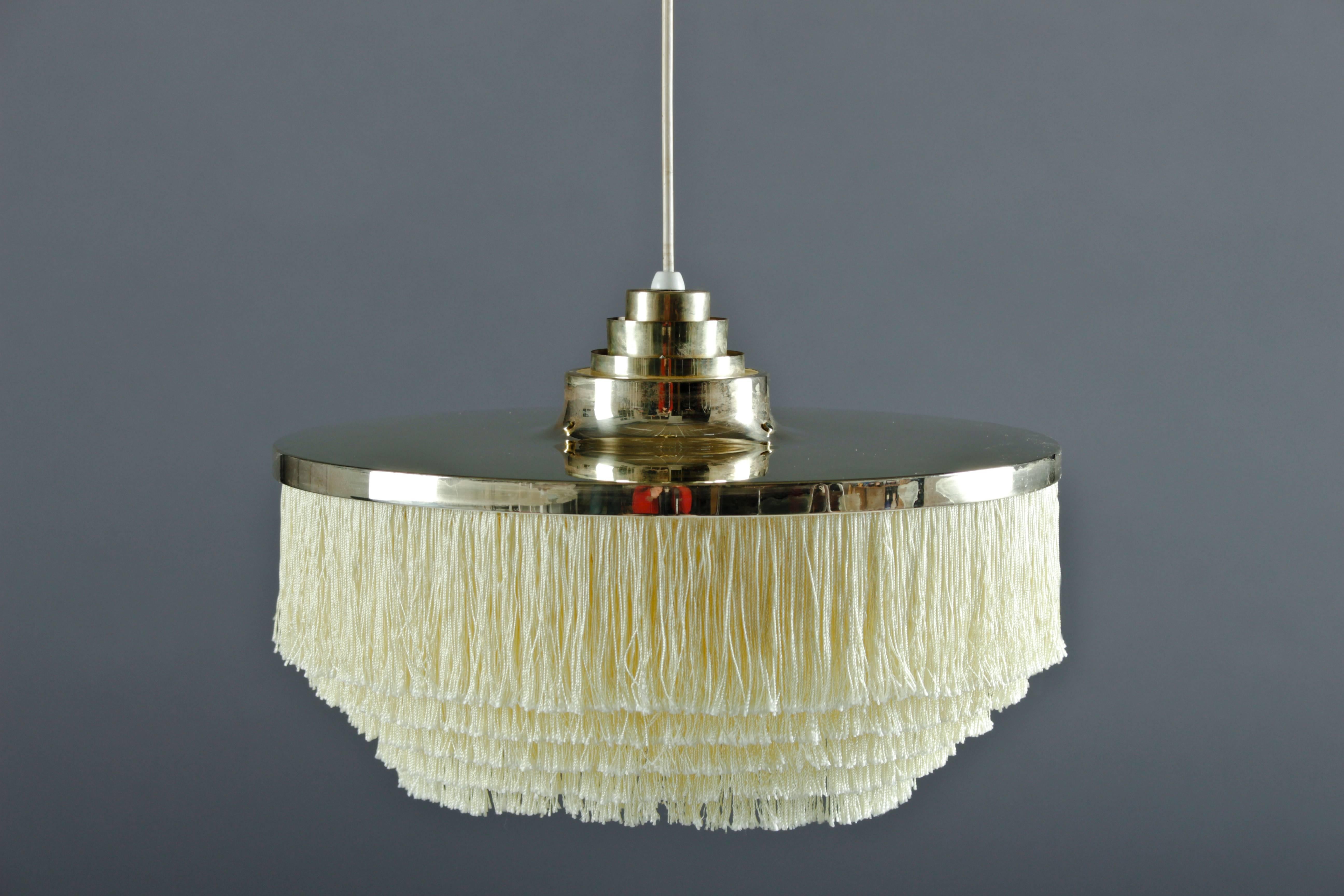 Ceiling light with brass frame and baby yellow silk fringes, by Hans-Agne Jakobsson for Markaryd in Sweden. The lamp is in very good condition, with only small signs of age and use. The brass parts can be polished by us to brand new look if wanted.