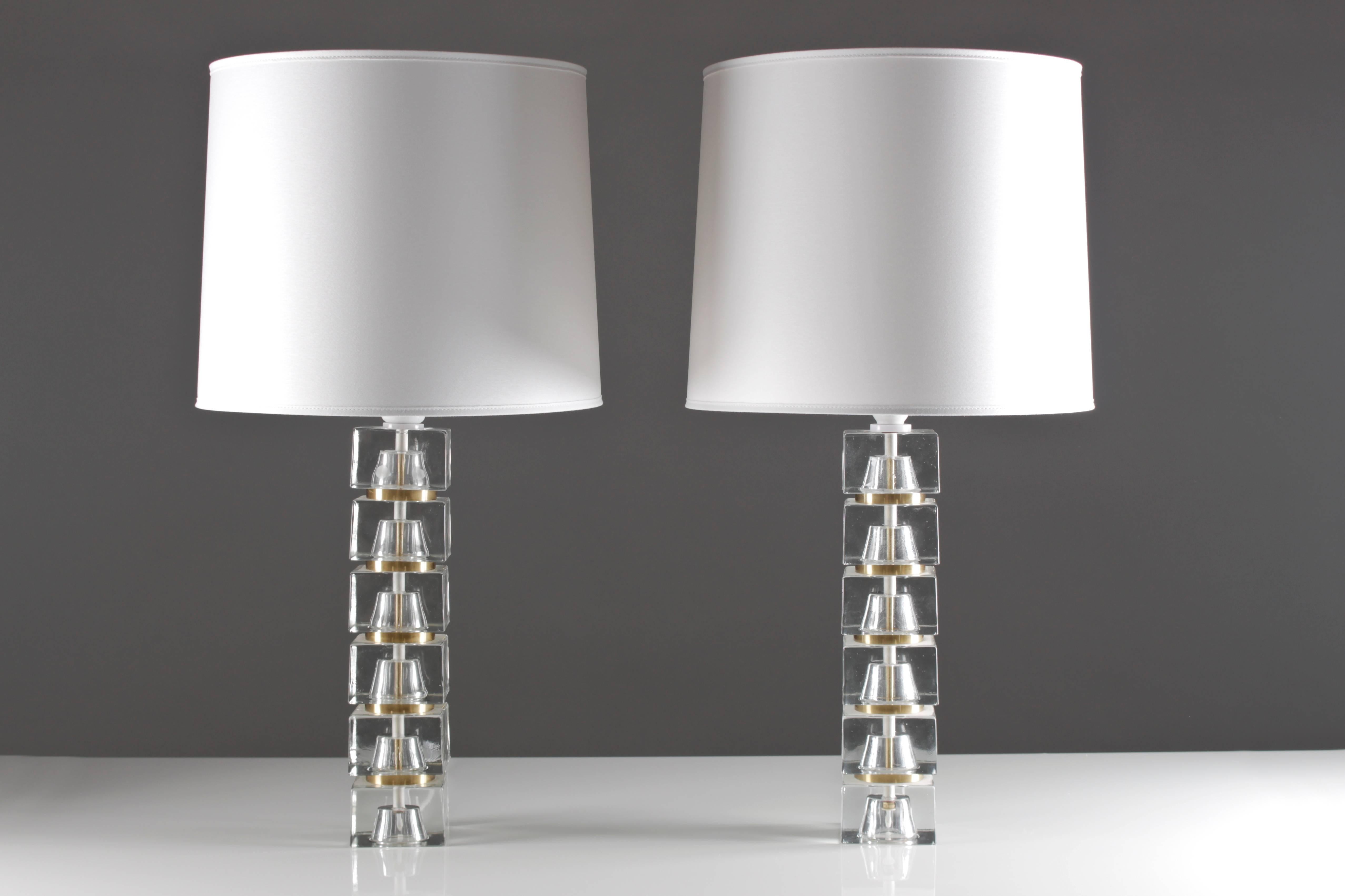 Stunning table lamps with cubes in clear glass, divided by rings in brass, possibly made by Carl fagerlund for Orrefors 
The lamps have been rewired.
Please note that the shades are not included in the price, but can be included for an extra cost