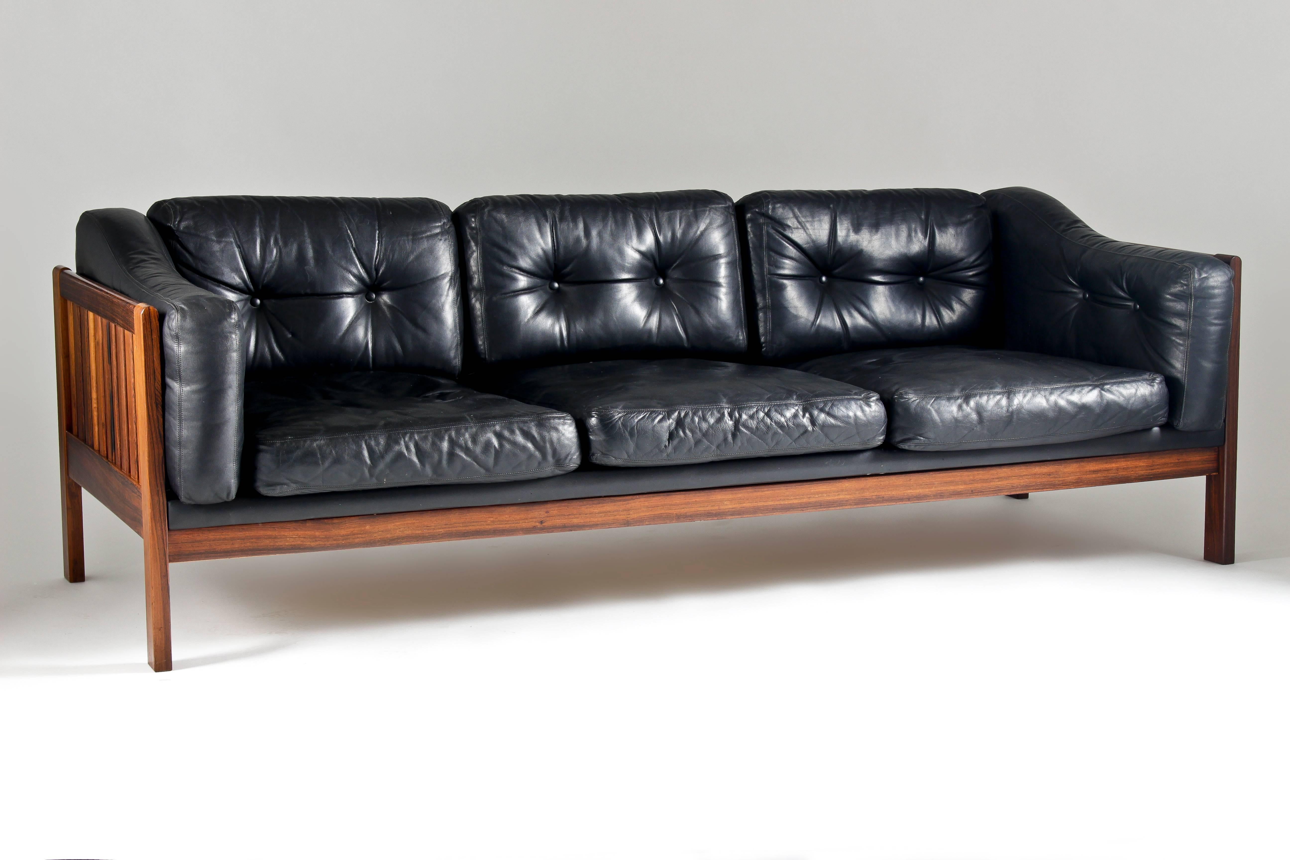 High-quality three-seater sofa designed by Ingvar Stockum for Futura Möbler in 1965. This sofa was only in production for two years because production costs were too high. This top-quality version is made of solid Brazilian rosewood and