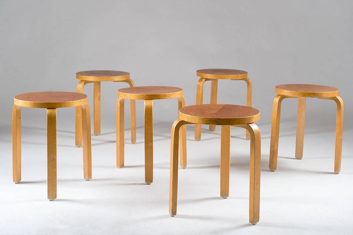A set of six stools model 60 by Alvar Aalto. These stools were manufactured in Sweden during the early 1950s. This model with teak veneer on top is rarely seen. These stools show a rough original patina after 60 years of use by the original owners