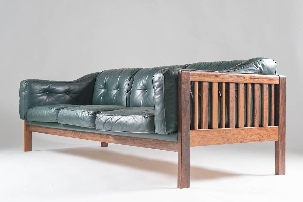 Top-quality sofa designed by Ingvar Stockum for Futura Möbler in 1965. This sofa was only in production for two years because production costs were too high. This luxury version with its frame made of solid rosewood and leather cushions filled with