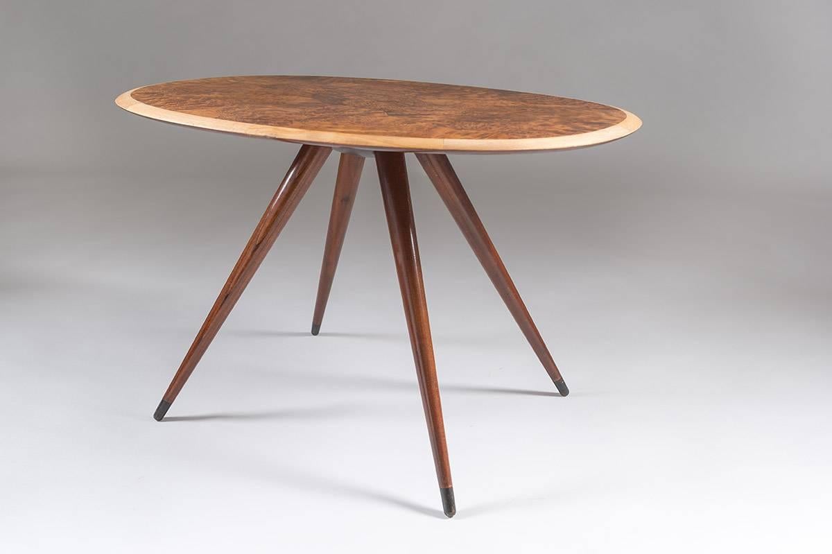 Beautiful and elegant coffee table attributed to David Rosén. The discreet pattern of elm root inlay on the table top, together with the distinct angled legs give this table an interesting mix of elegant luxury and attitude.
The table is in