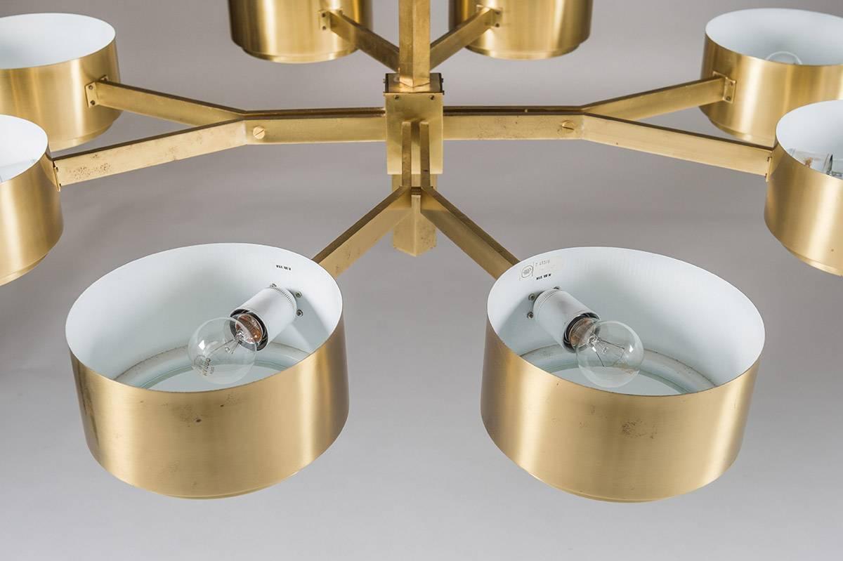 A magnificent chandelier by Hans-Agne Jakobsson, Sweden.
This model is very rare and among the finest that Hans-Agne designed.
The lamp features eight-light sources. Each bulb is surrounded by a circular brushed brass cylinder with a frosted glass