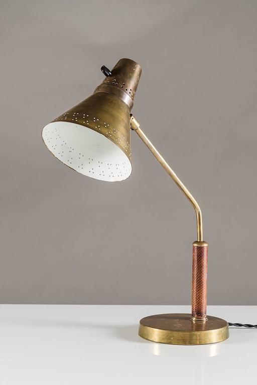 Beautiful desk lamp by Swedish manufacturer AB E. Hansson & Co., circa 1940. The shade is made of brass with perforations around the edge, giving a beautiful light. The shade is fixtured on a brass stem and is adjustable in any direction. The brass