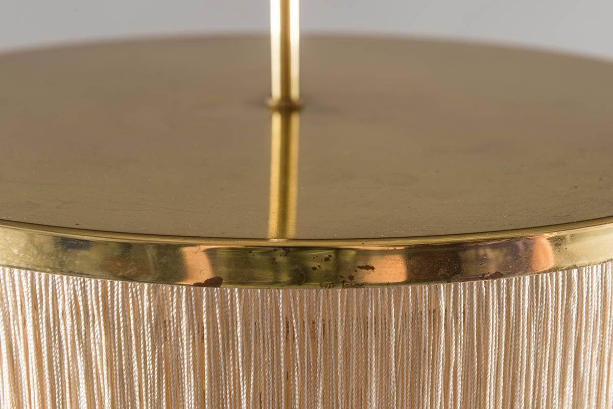 Ceiling light with brass frame and cream white silk fringes by Hans-Agne Jakobsson for Markaryd in Sweden, from the Scandinavian Mid-Century Modern era.
Condition: This lamp is in good original condition. The brass has some dark spots and one
