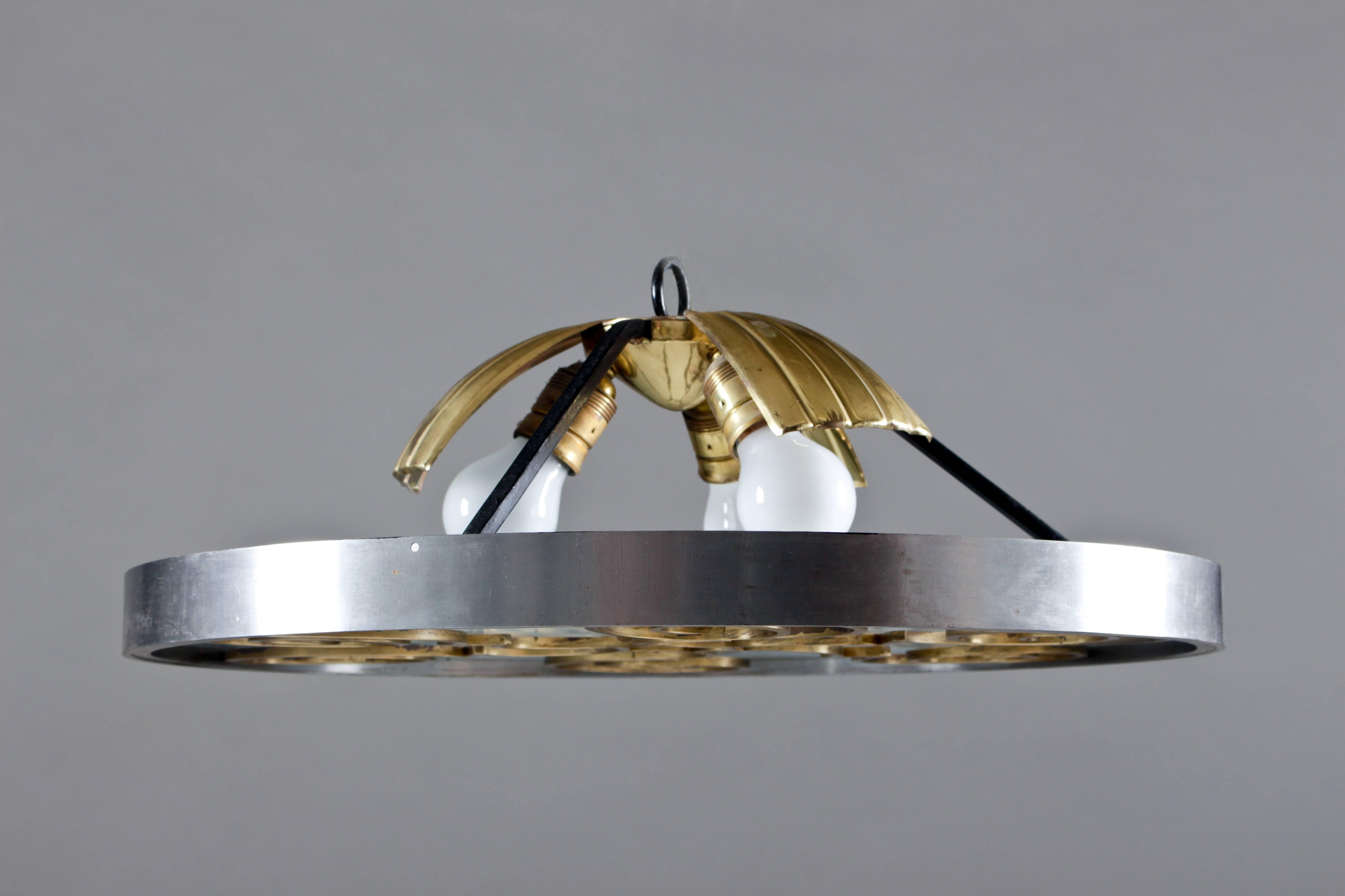 Art Deco flush mount by Lars Holmström Arvika made of brass, steel and frosted glass.
The lamp was bought from the designer himself. Later, the lamp was repaired (the glass was replaced); an invoice is included with the autograph of Lars