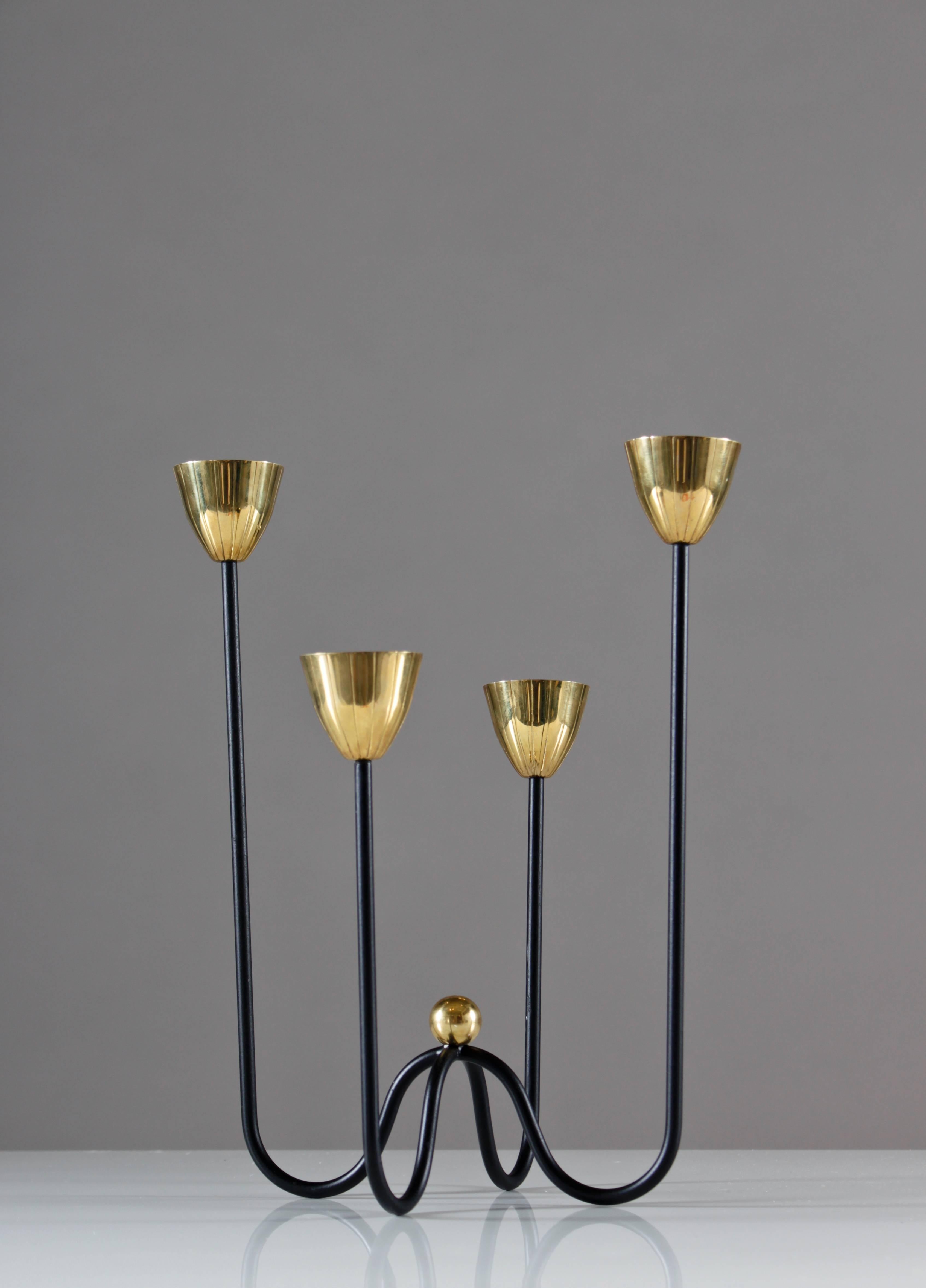 Pair of black lacquered candelabra with candleholders of brass, designed by Gunnar Ander for Ystad Metall (Sweden.)