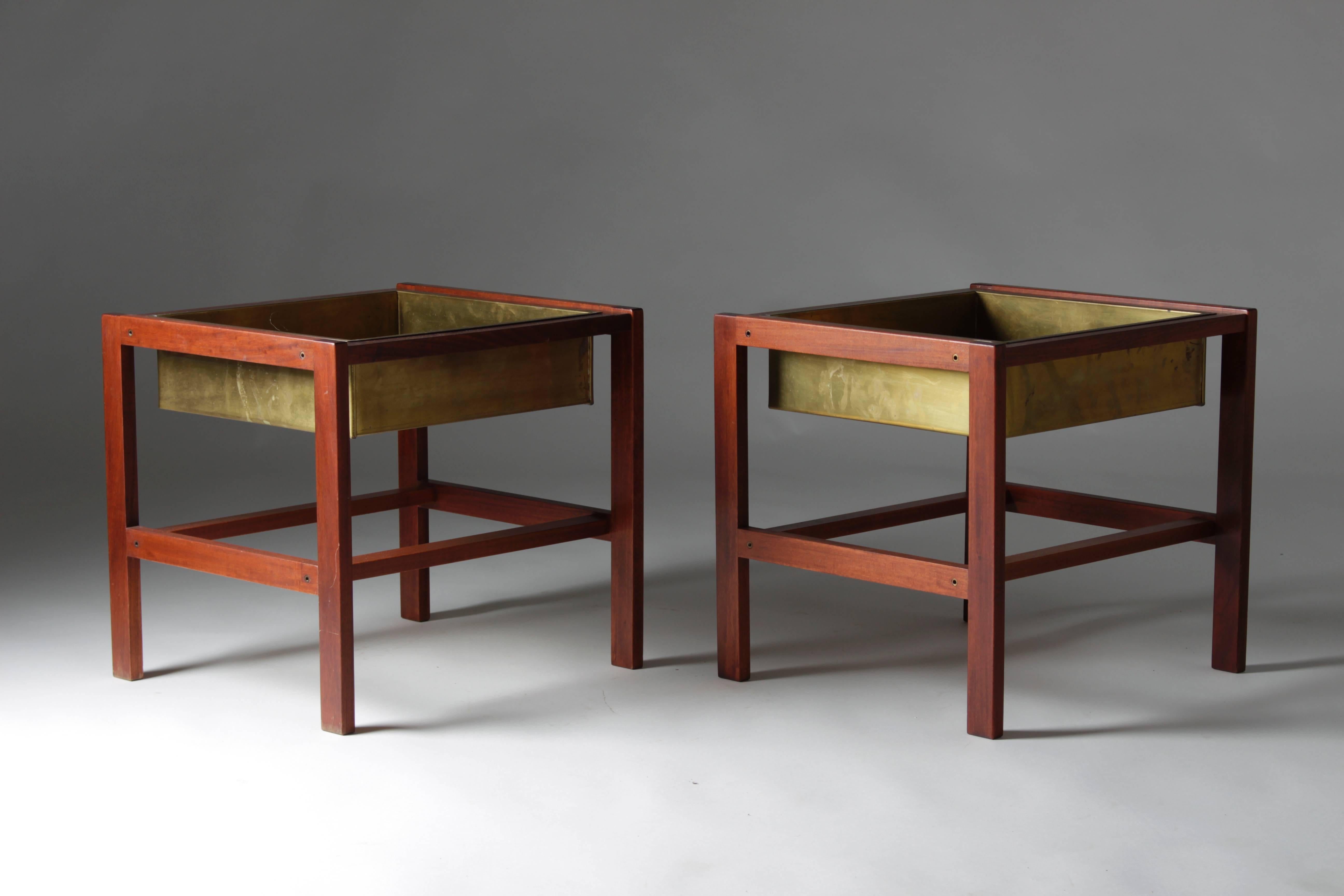 A pair of beautiful side tables with a frame made of dark teak and trays in solid natural patinated brass. Probably manufactured in Scandinavia.
