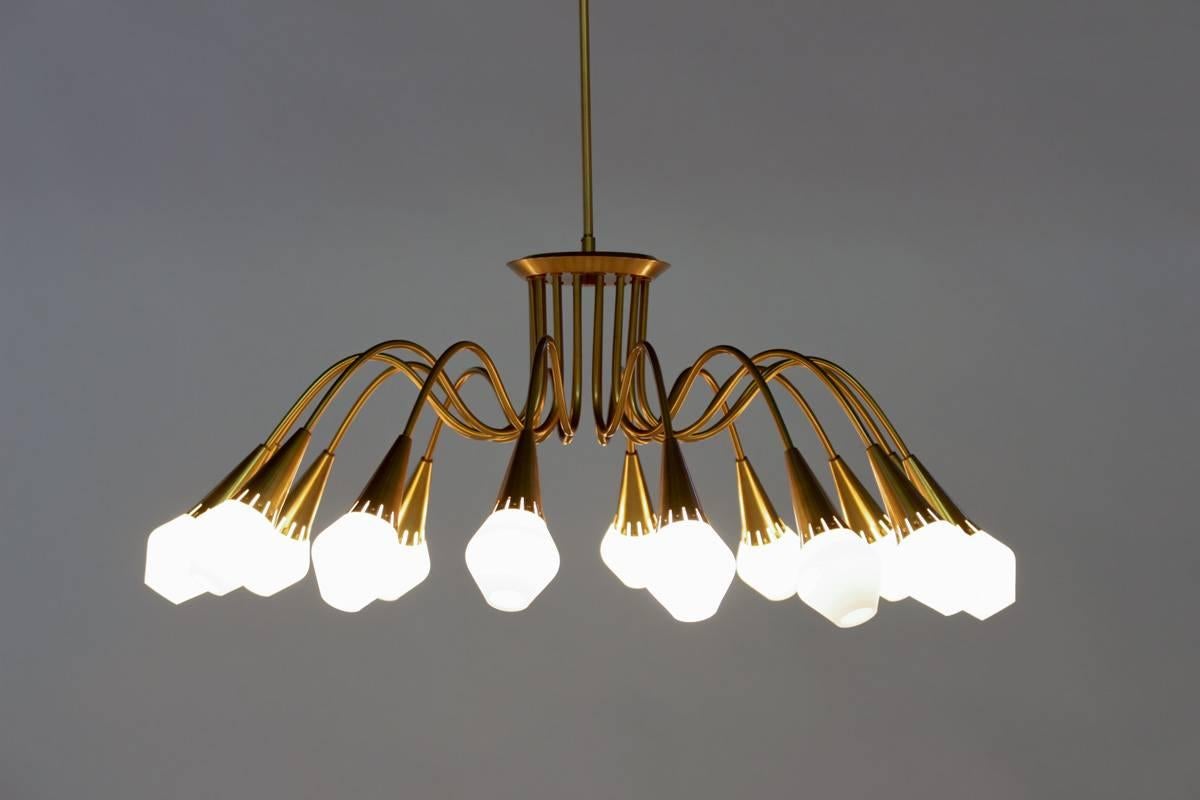 Huge Swedish chandeliers made of brass with shades in opaline glass. 
These chandeliers came from a cinema that was built in the early 1950s. The dark and dry atmosphere has preserved these lamp perfectly; they are in absolute mint condition.