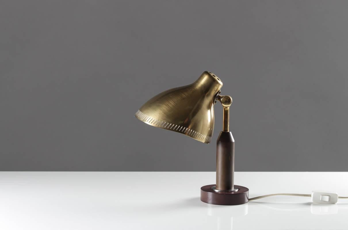 A small table lamp in brass and bakelite attributed to Hans Bergström. The organically shaped shade is beautiful from every angle and gives a beautiful light with its perforated edge. 
Free shipping in Europe and low rates to other destinations.