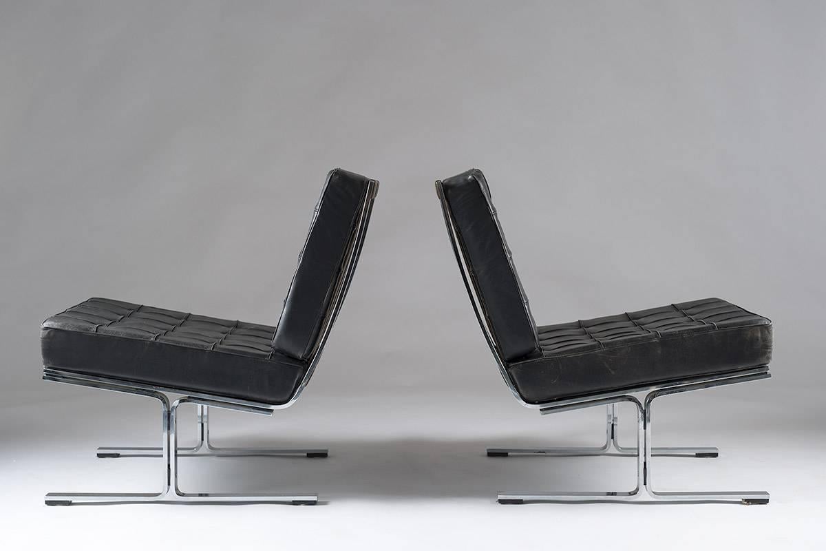 A pair of rare lounge chairs model F-60 by Karl-Erik Ekselius for JOC Vetlanda. These high-quality chairs were among the most exclusive made in Sweden during the 1960s. The chairs feature a heavy chrome metal frame and black leather cushions. The