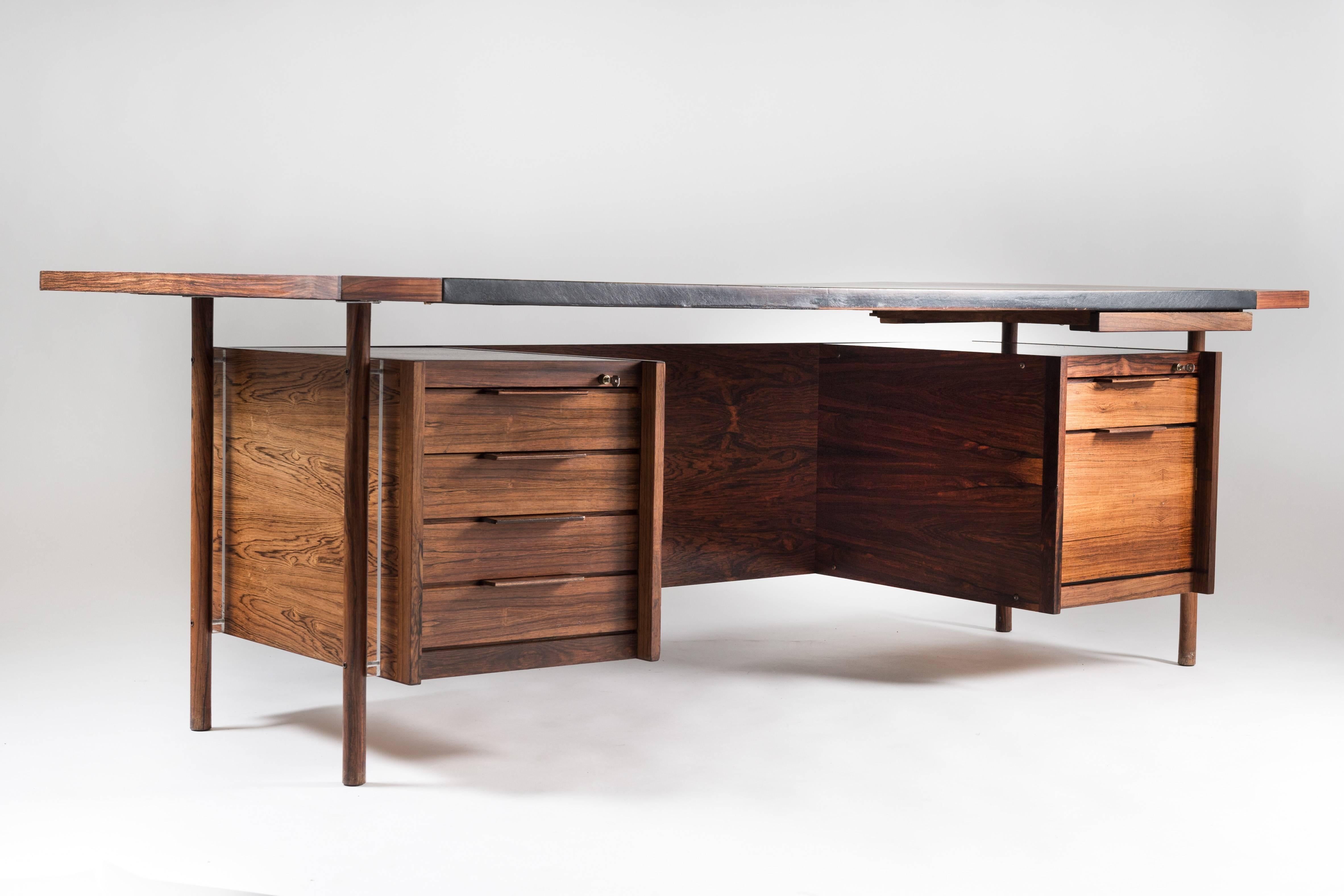 Amazing executive desk by Norwegian designer Sven Ivar Dysthe for Dokka Møbler. The desk features a frame made of rosewood and a tabletop of perfectly patinated leather. The legs, made of solid rosewood, support the drawers with a plexiglass