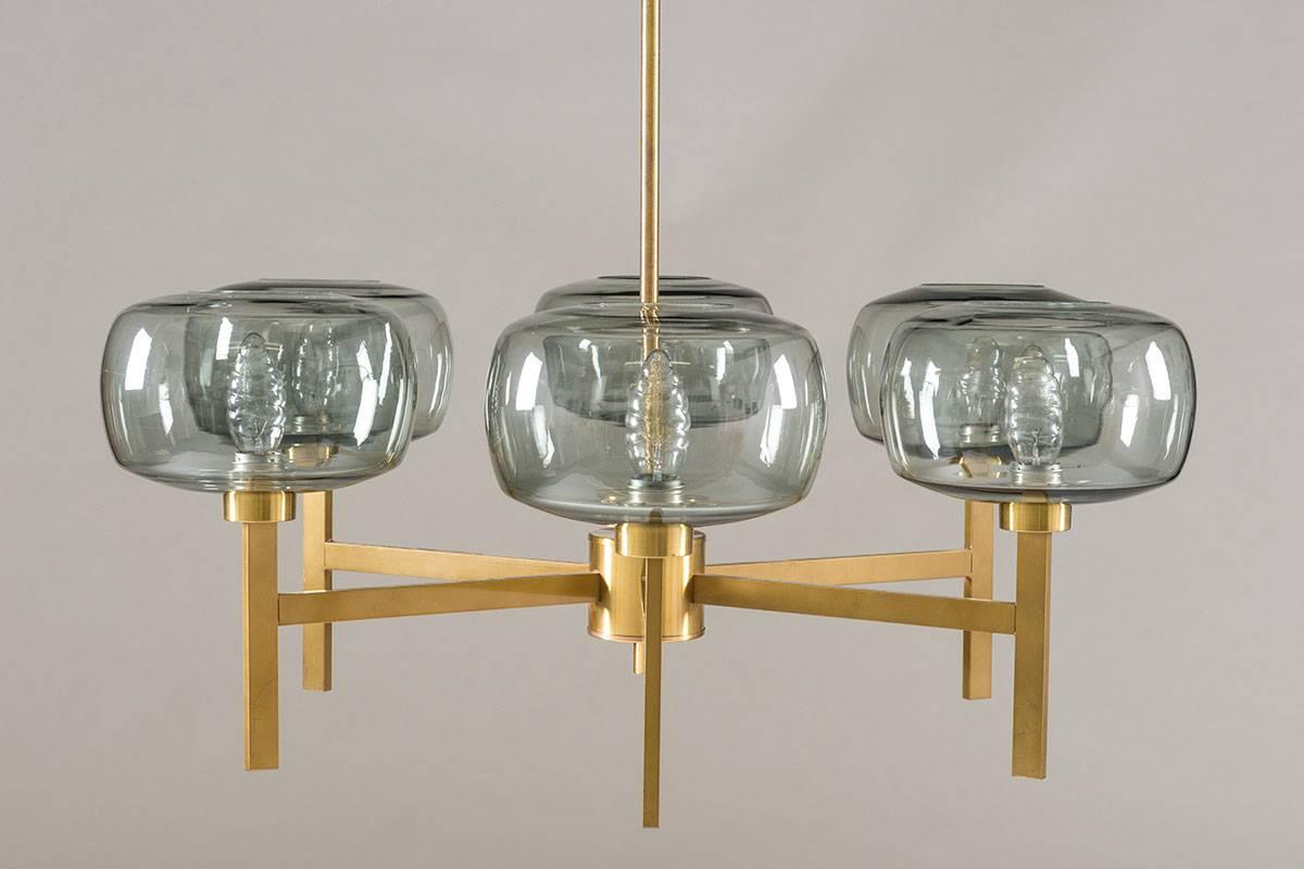 Large chandelier by Holger Johansson for Westal, Sweden.
These beautiful chandelier consist of six rectangular T-shaped brass poles, each holding a grey-blue glass sphere.
The rods can be adjusted to your desired length up to 4 meters.
Each sphere