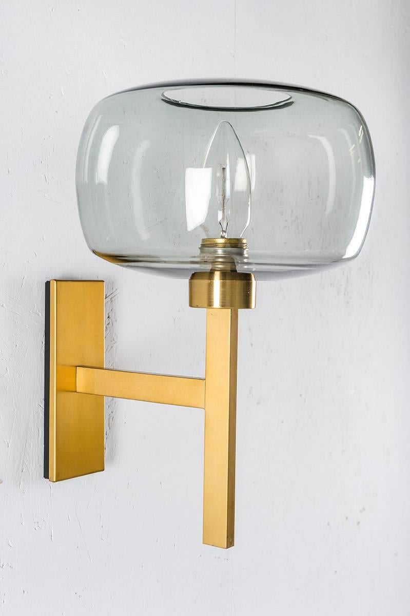 Wall lamps by Holger Johansson for Westal, Sweden.
Wall lights of beautiful clean design featuring a rectangular brass frame and a grey-blue glass sphere.
The lamps come from a church in Forshaga, Sweden, which was built in the 1960s.

Condition: