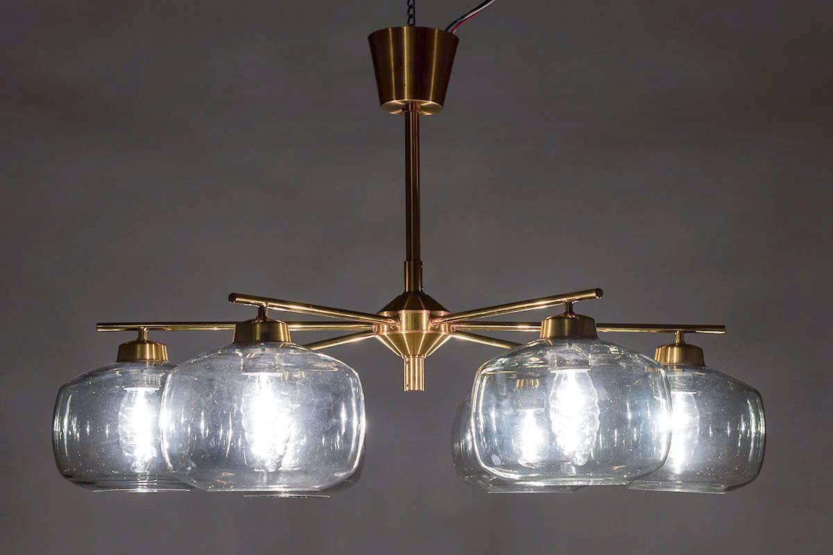 Pair of chandeliers by Holger Johansson for Westal, Sweden.
The chandeliers consist of six round brass poles, each holding a grey-blue glass sphere. 
The rods can be adjusted to your desired length up to 4 meters. 

The lamps come from a church