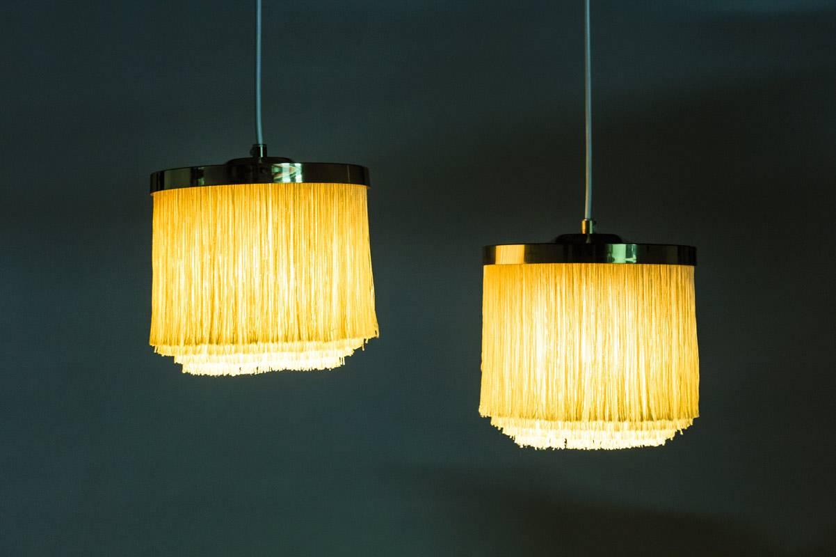 Pair of ceiling lights with brass frame and yellow silk fringes by Hans-Agne Jakobsson for Markaryd in Sweden, from the Scandinavian Mid-Century Modern era.
Condition: The lamps are in very good condition. The brass only shows small signs of use