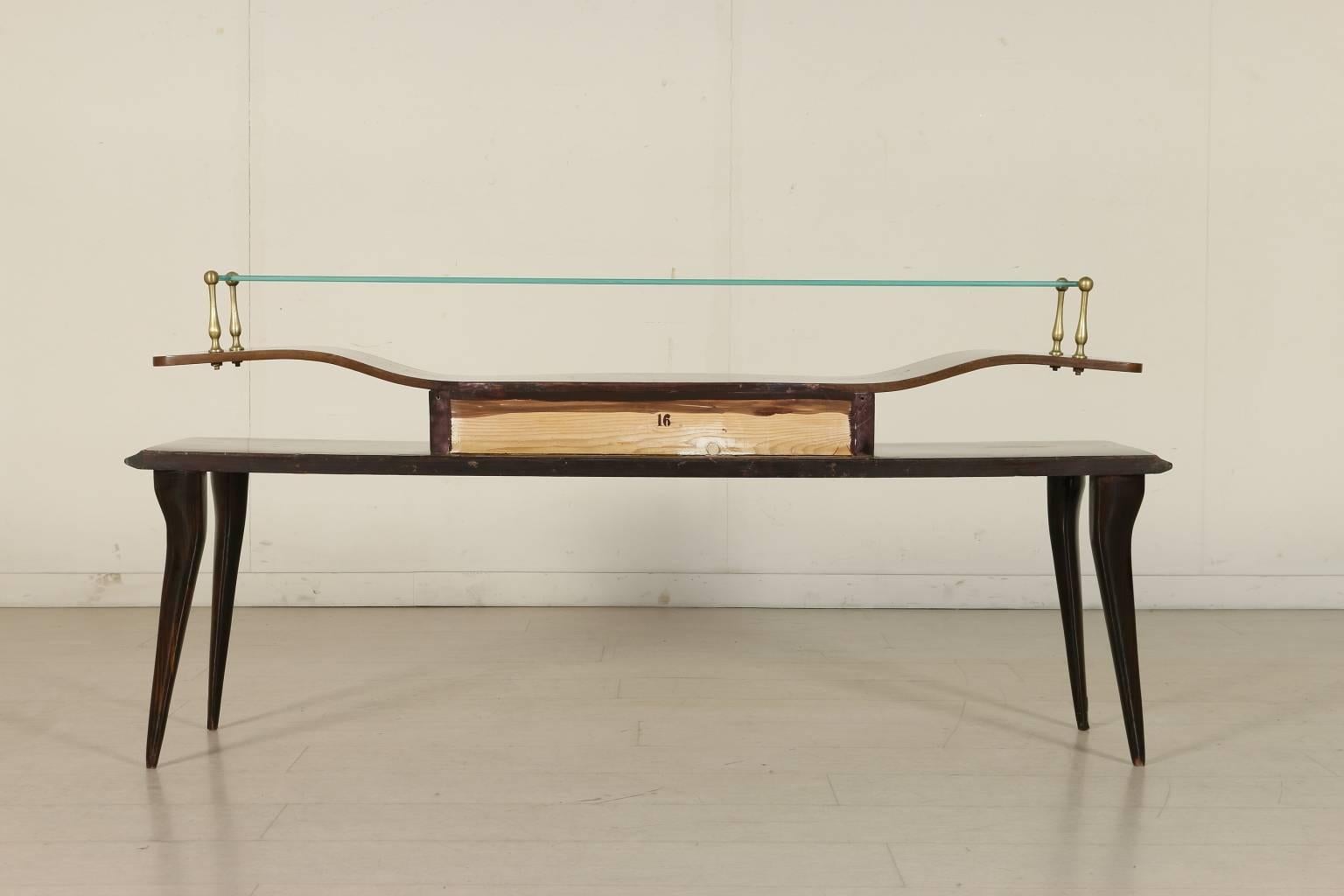 A graceful console, rosewood veneer, ebony stained wood, glass, brass. Manufactured in Italy, 1950s.