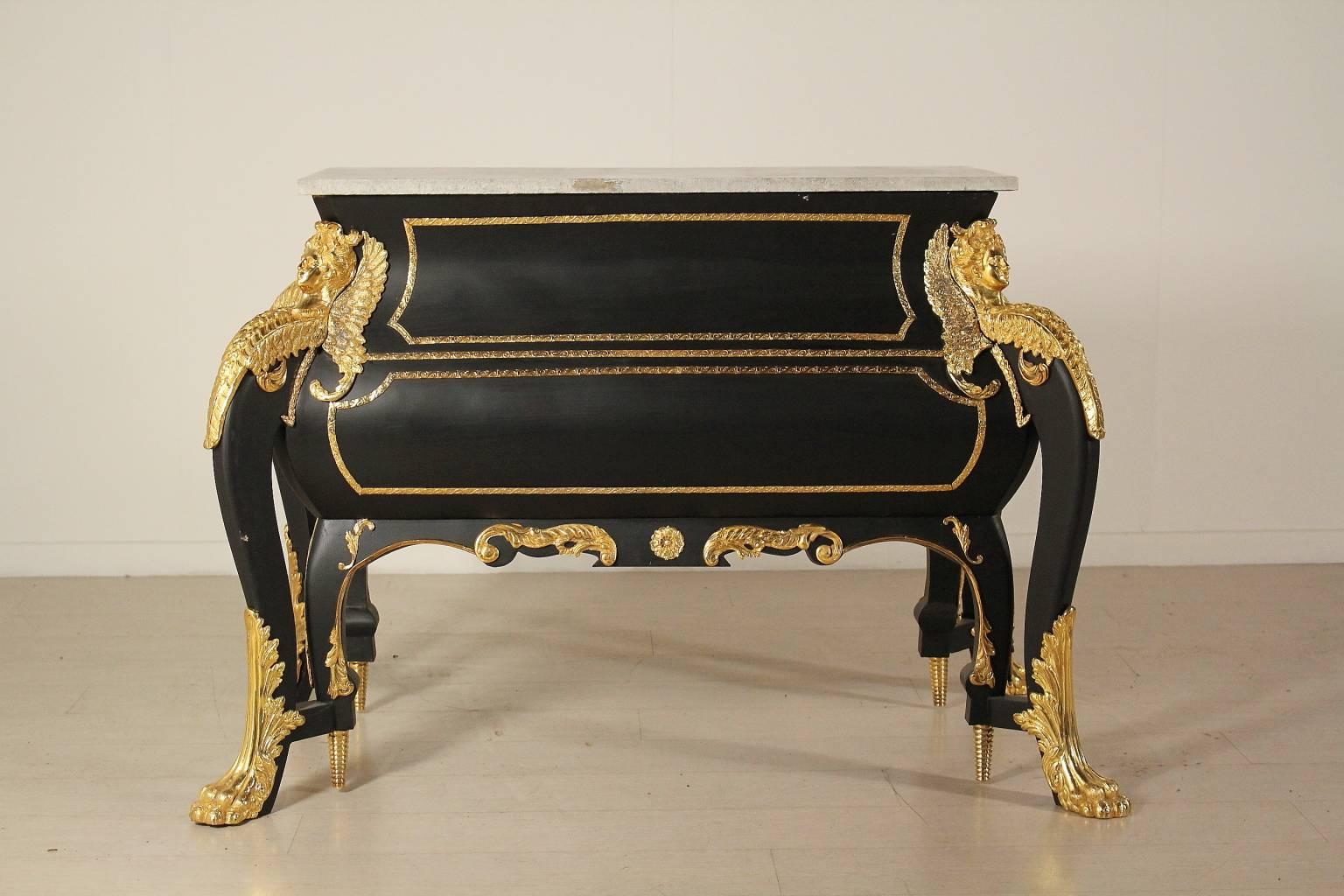 A chest of drawers, copy of the well-known chest of drawers made by C. Boulle and placed now at Vaux-le-Vicomte castle. Moved line, four pairs of legs and two drawers. Brass friezes, marble top. Manufactured in Italy, second half of the 20th century.