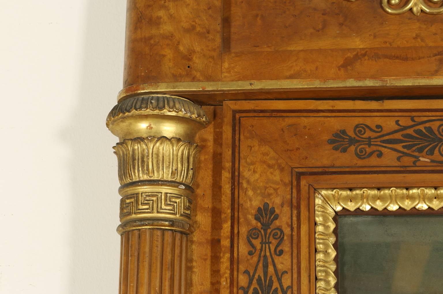 A maple mirror of the Restoration period with stiles, columns decorated with gilded capitals. Plaster inlaid edges and frames. Amaranth decorations. French mirror with gilded frame. A band with sophisticated gilded carvings. Made in Piemonte
